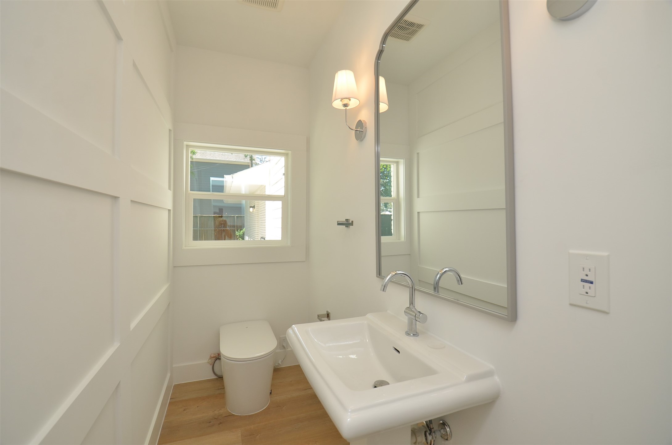 Half bath with Smart toilet conveniently  located downstairs for family and guests.