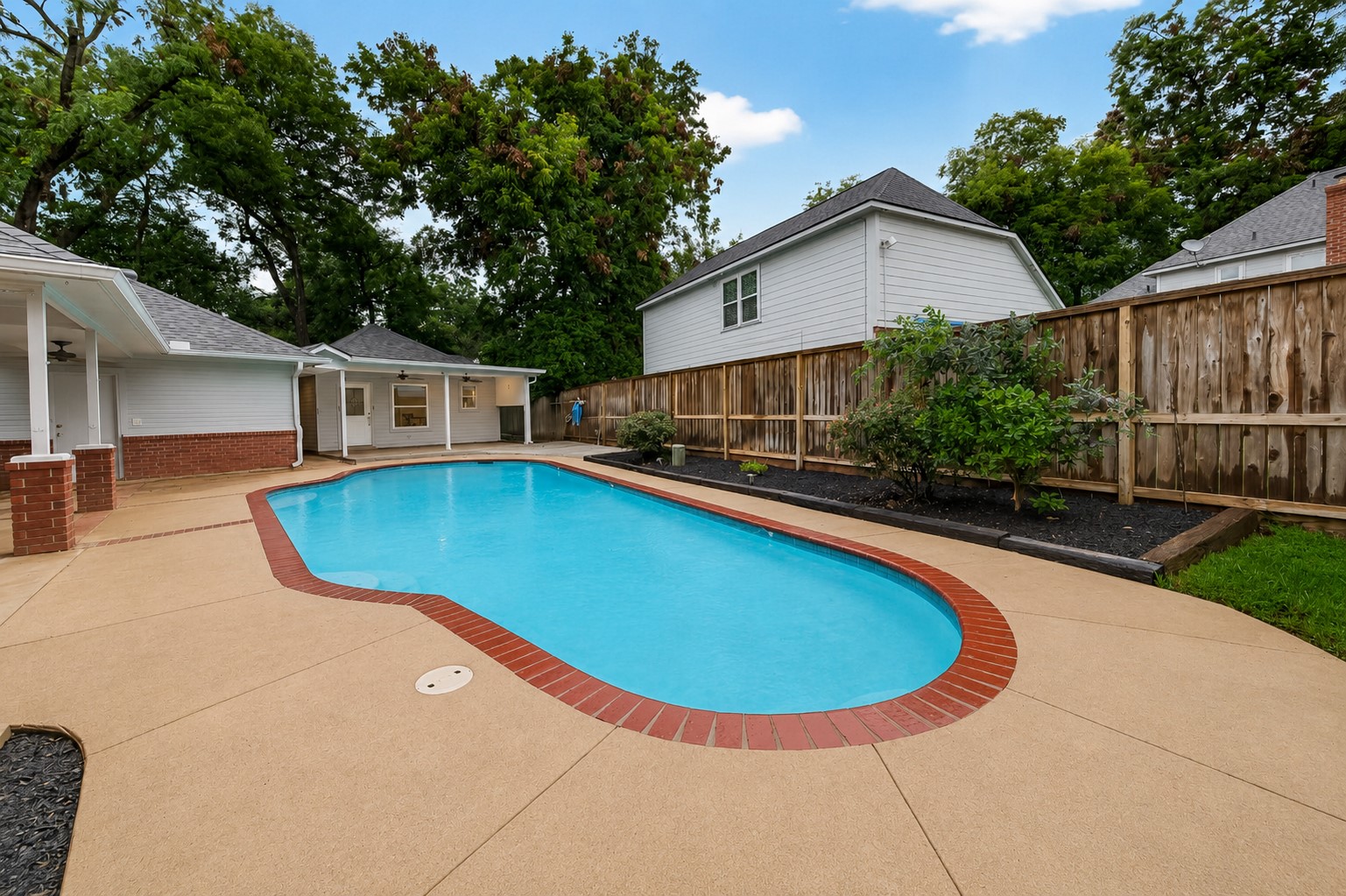 Sparkling Swimming Pool with extensive decking surrounding it!