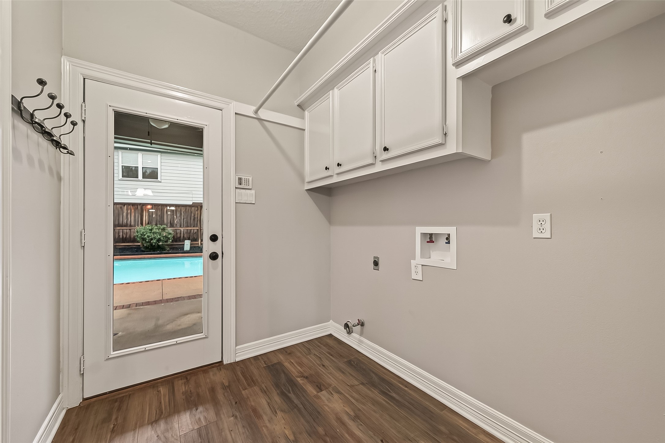 Large utility Room with a 1/2 bathroom that is easily accessible near the pool area!
