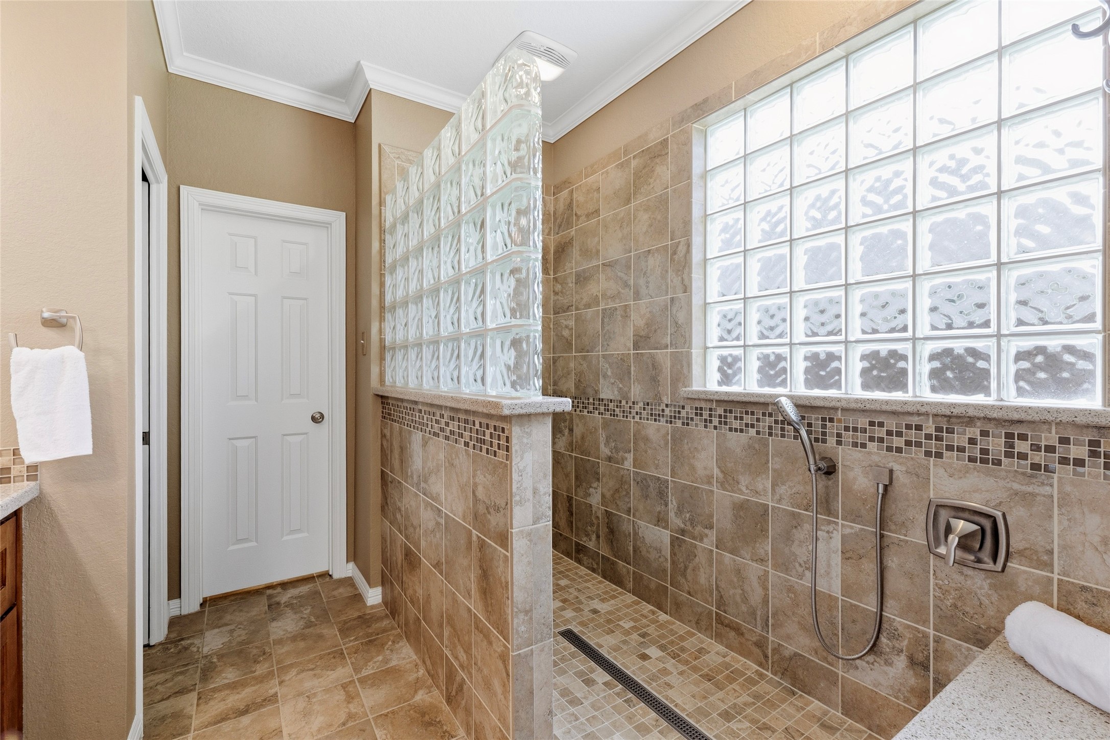 Shower is a must see with the custom tilework, Kohler fixtures, and shower bench.