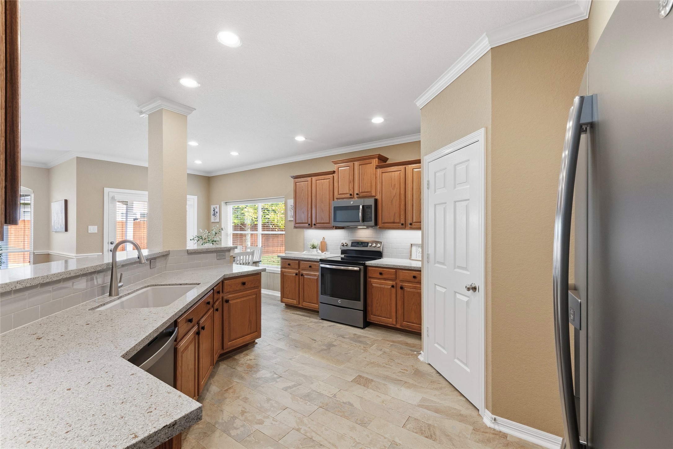Updated kitchen inlcudes Quartz countertops, Kohler cast iron undermount sink, subway tile backsplash, updated faucet, and under-cabinet lighting.