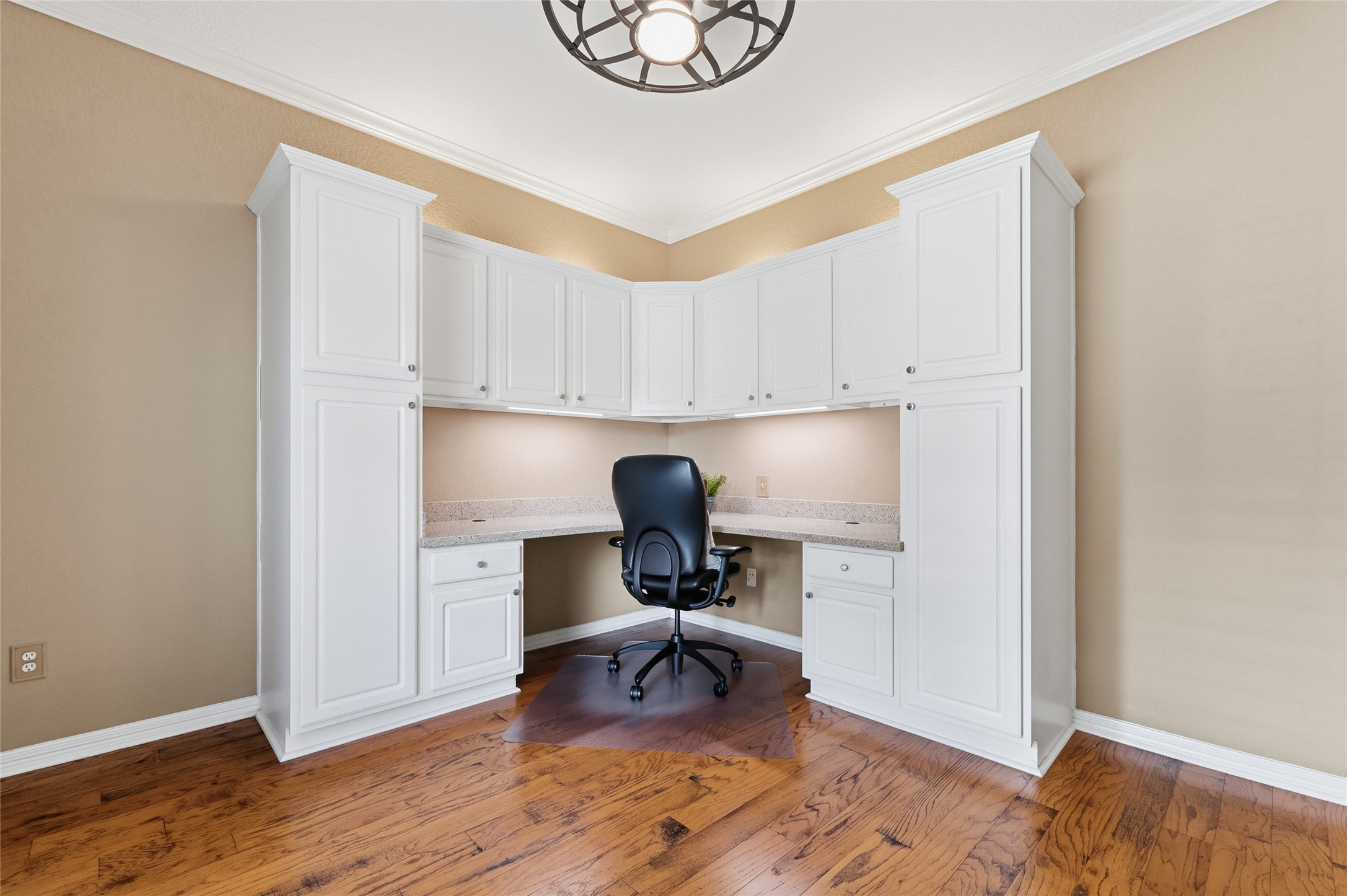 Home office has custom built-ins with Quartz countertops.