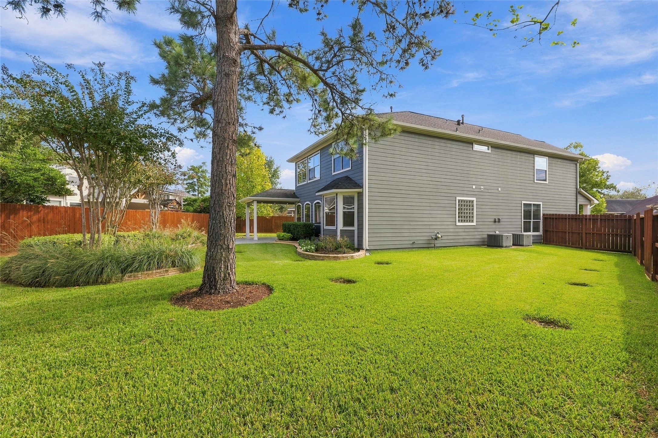 Huge backyard for your enjoyment and complete with a stained perimeter fence and French Drains.