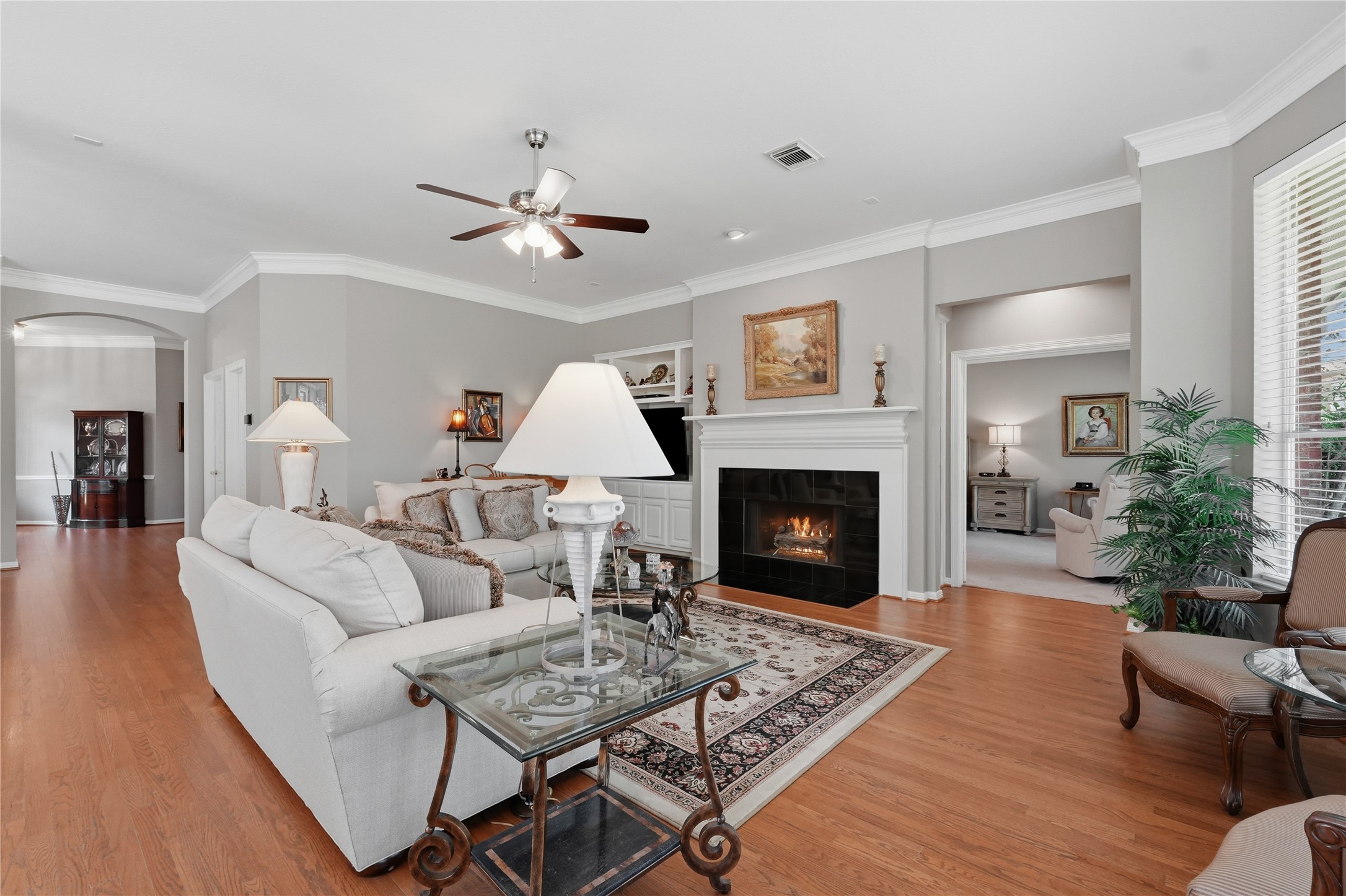 Notice the wood flooring and crown molding continues through the living room.