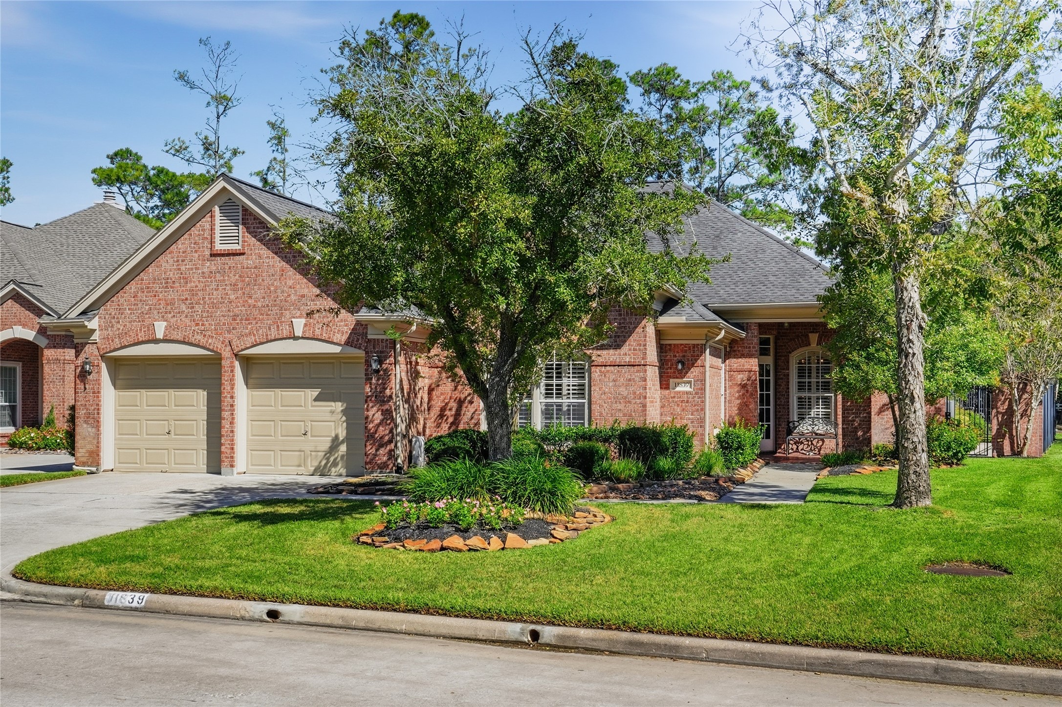 Beautiful full brick exterior is surrounded by mature landscaping.