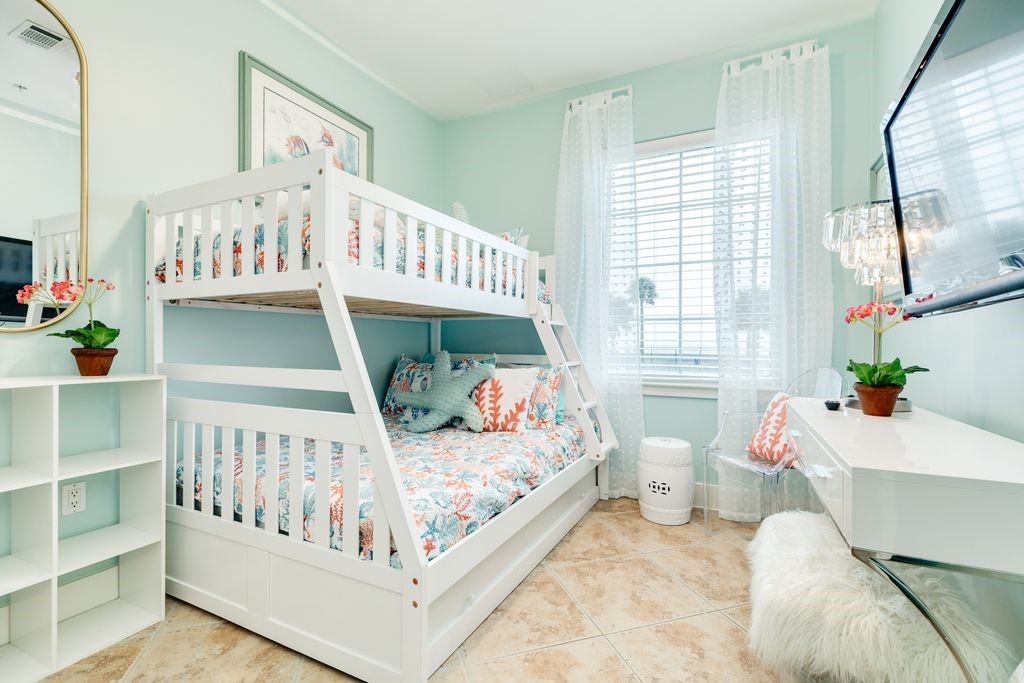 One of two secondary bedrooms with bunk beds and room for a desk