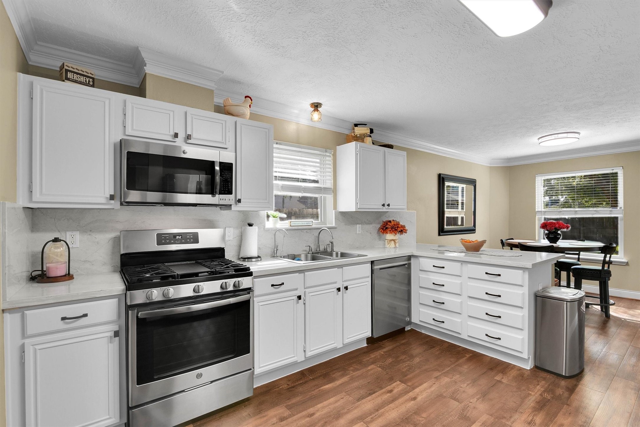 Gas range, eat-in bar, and kitchen nook.