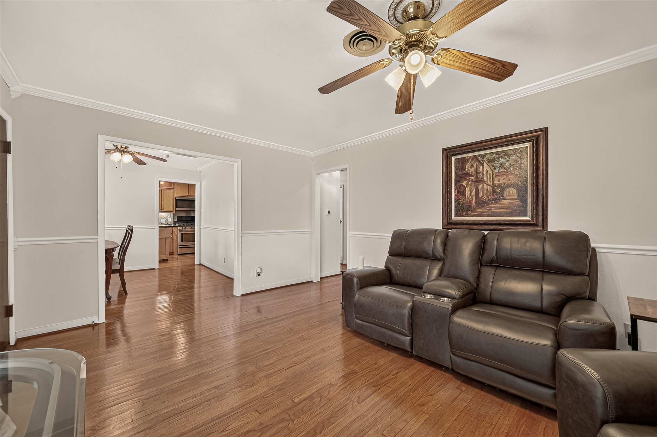 Living Room connects to the Dining room. Crown molding, and chair rail add a finishing touch.