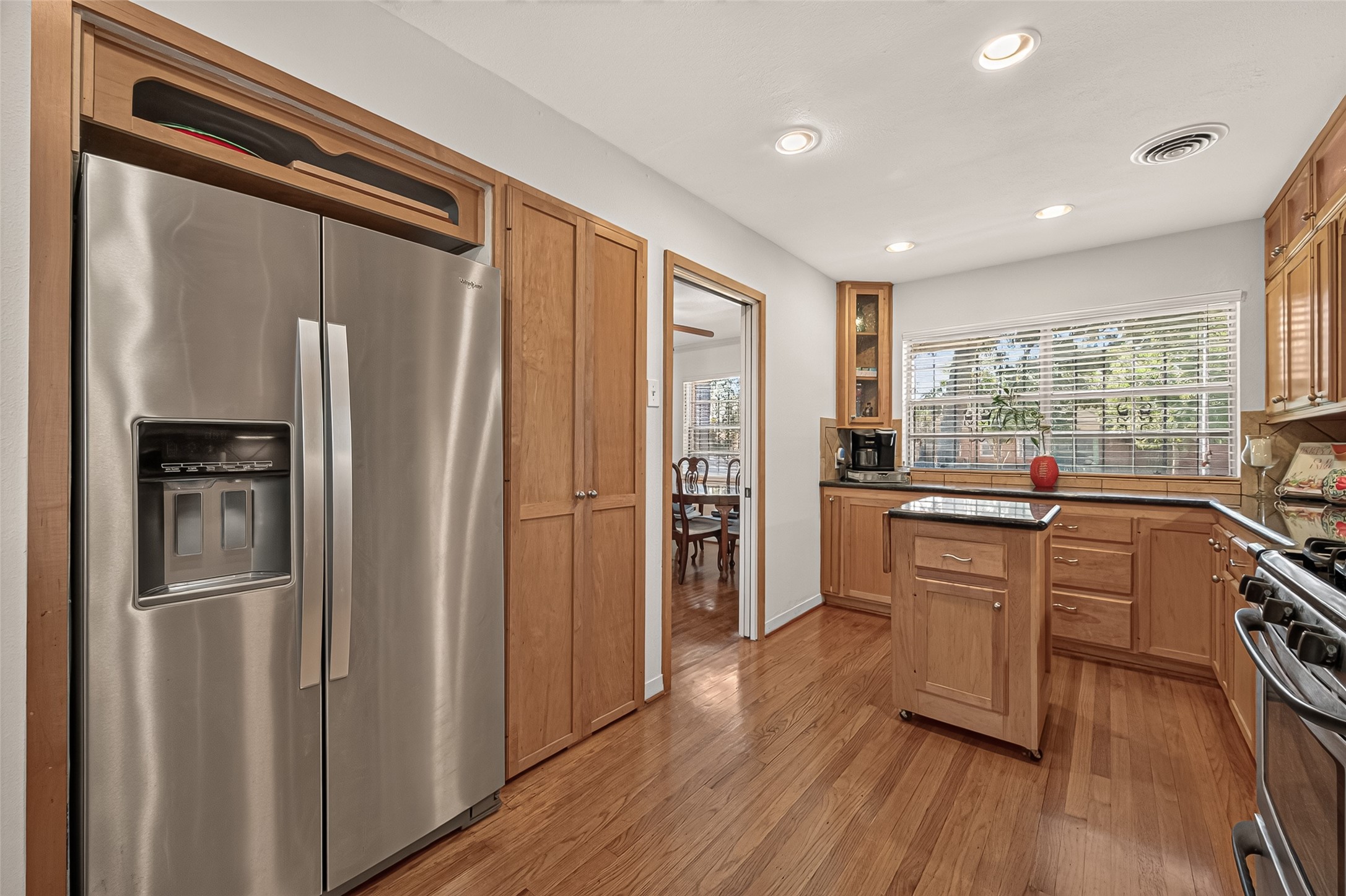 Large double door pantry. Extra storage above the refrigerator for large serving platters. Natural light fills the kitchen from the large window above the counter space.
