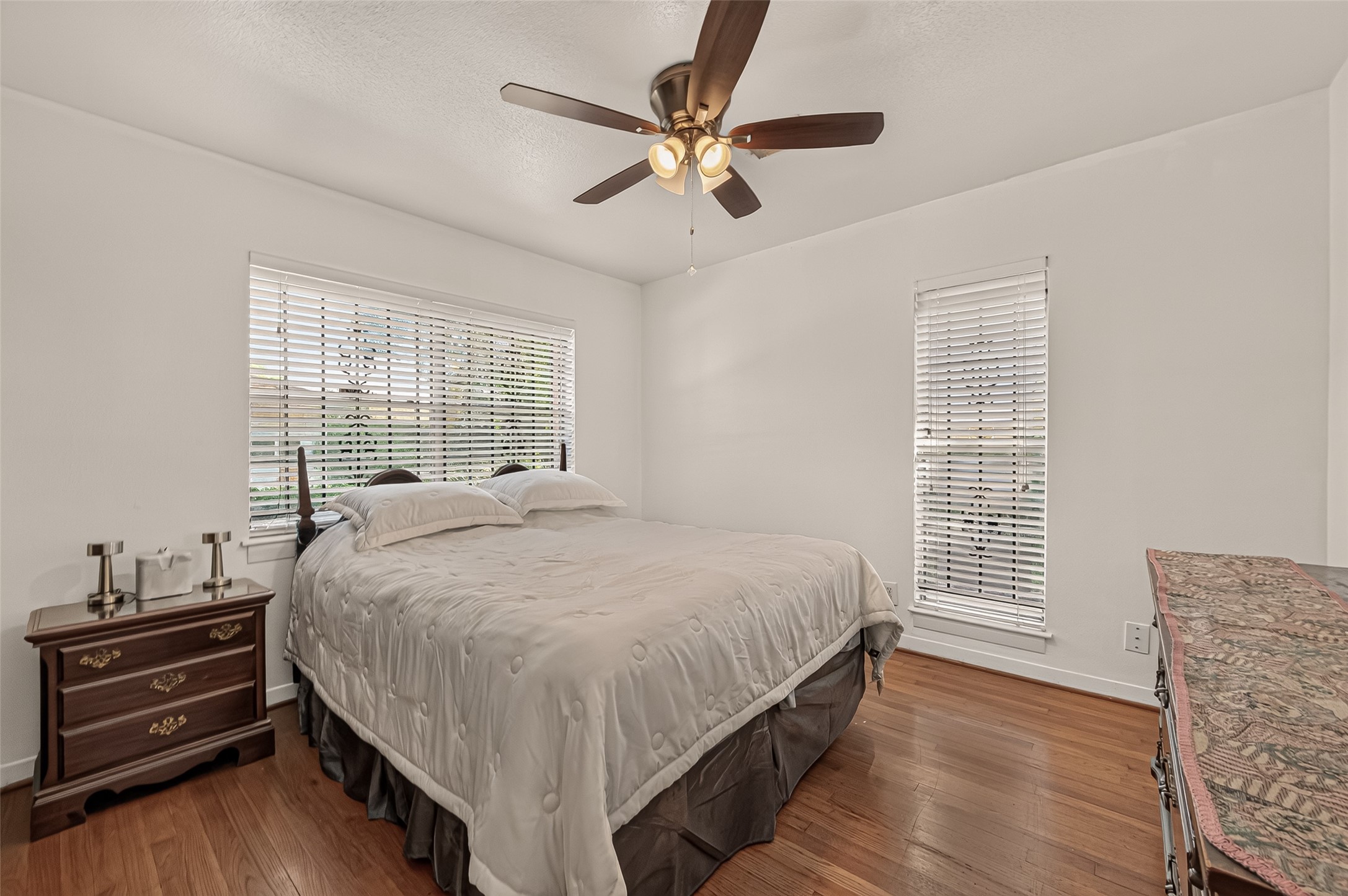 Secondary Bedroom. Original hardwood floor. Natural light from the large windows.