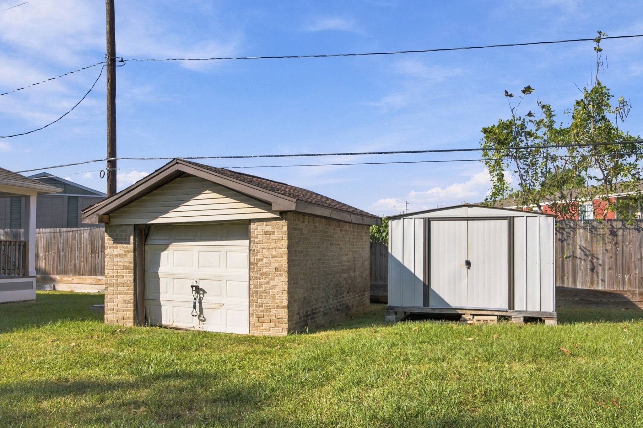 Detached garage and storage shed situated in the backyard, offering additional storage options.