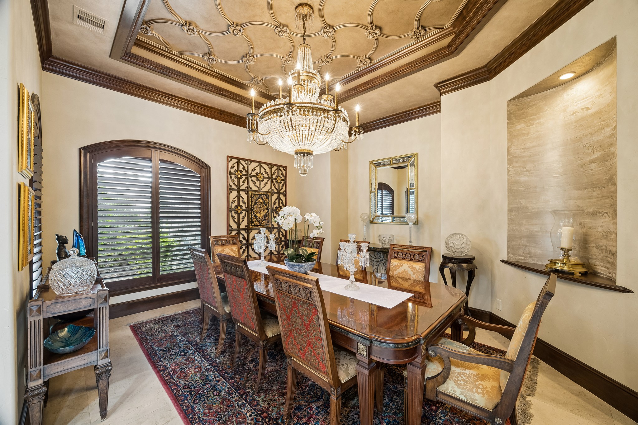 Elegant dining room featuring a stunning chandelier, intricate ceiling design, and rich wood accents, creating a warm and inviting atmosphere for entertaining. Elegant dining room featuring a stunning chandelier, intricate ceiling design, and rich wood accents, creating a warm and inviting atmosphere for entertaining.