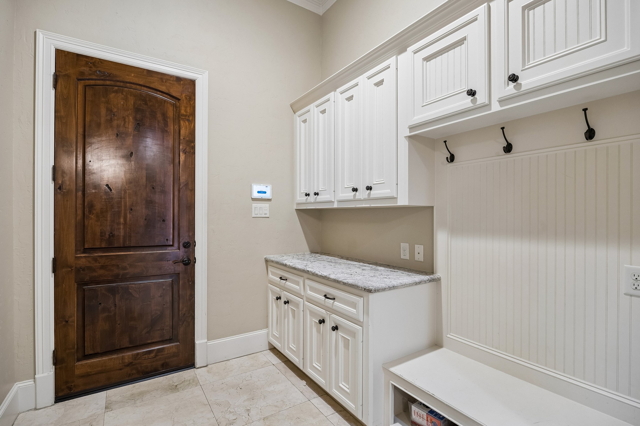 The mudroom is conveniently located off the 3 car-garage and is adjacent to the utility room and a second powder room.