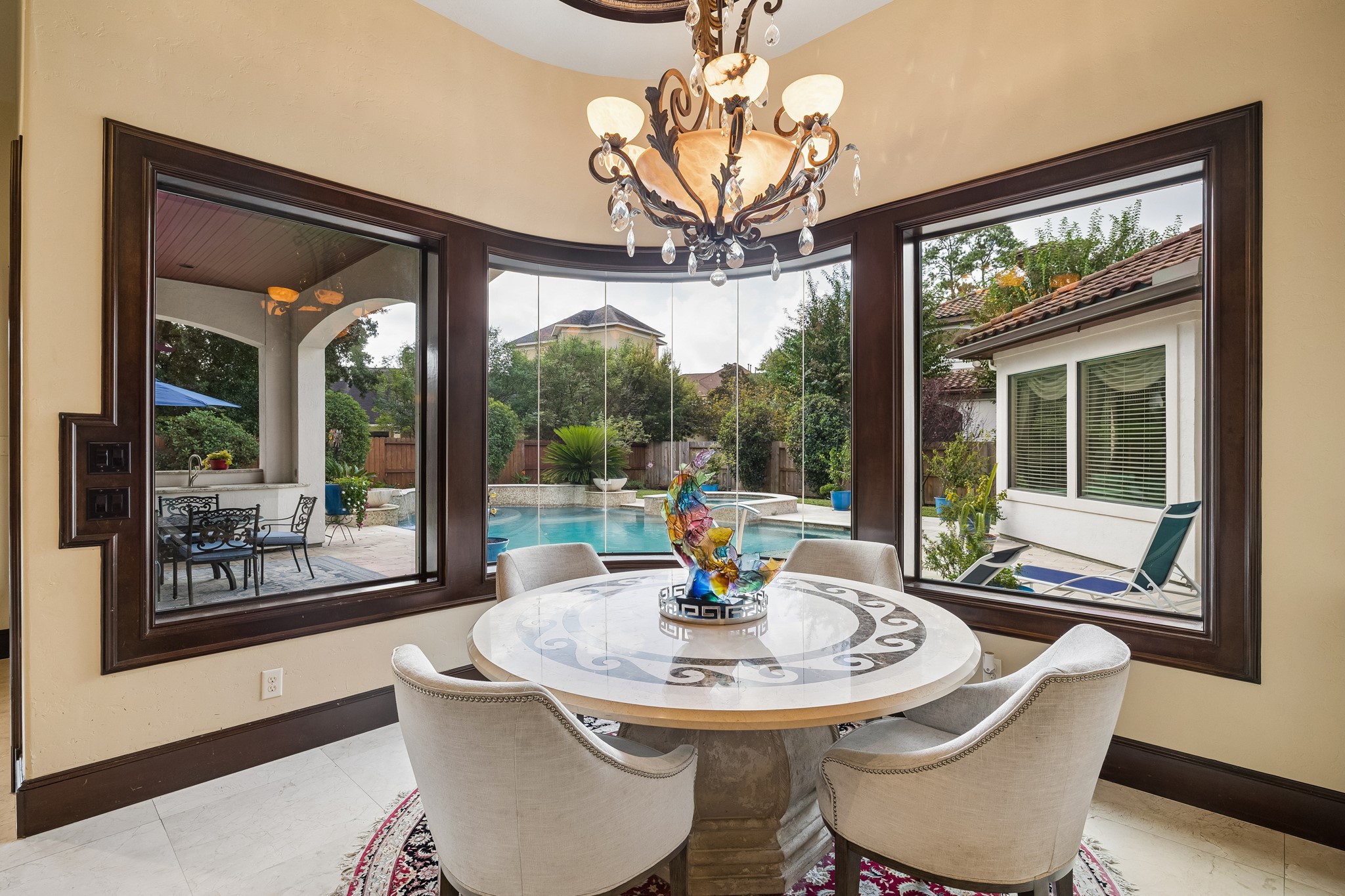 The breakfast room is perfectly situated and offers stunning views of the pool and landscaped backyard through large bay windows.