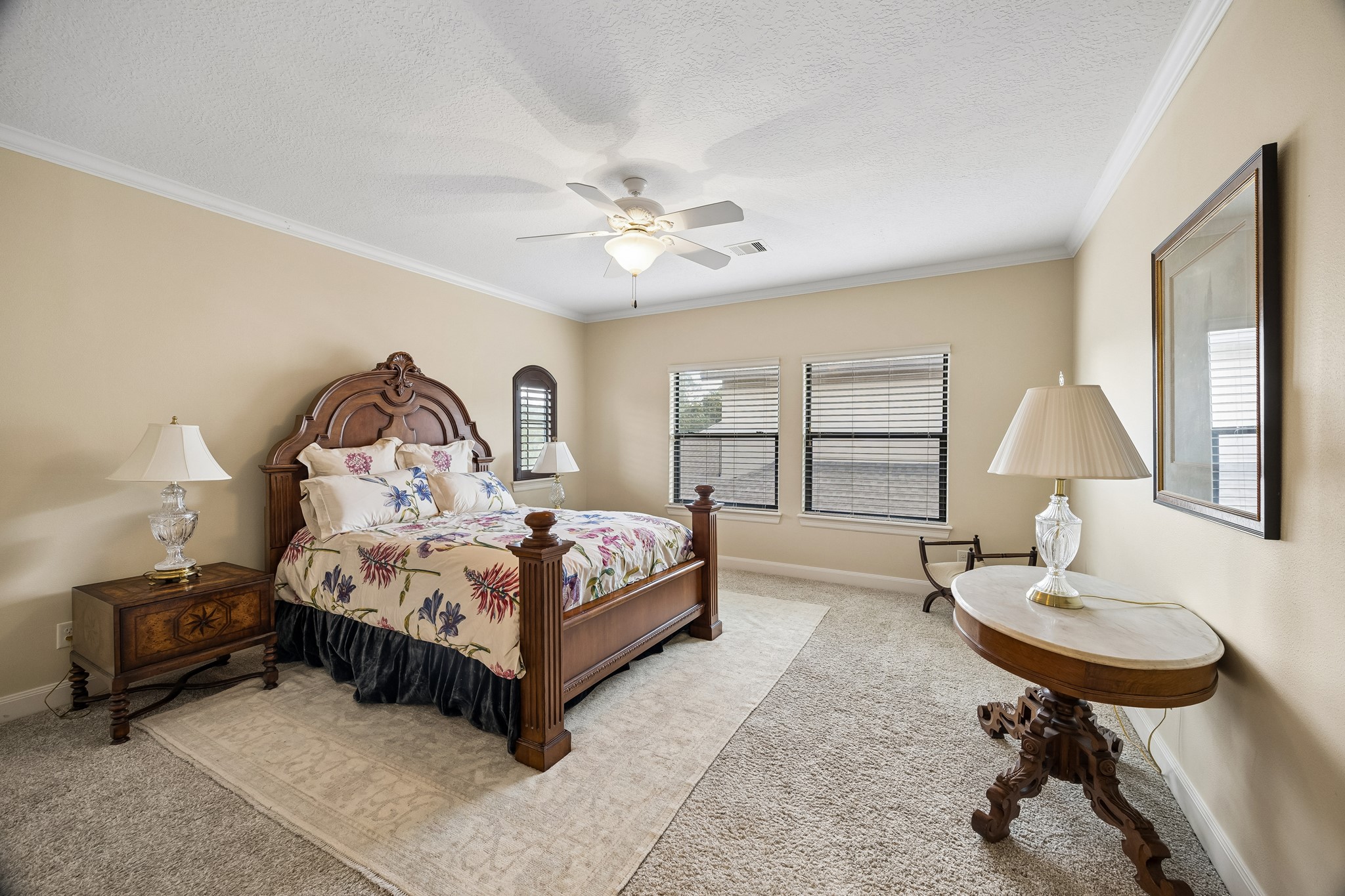 Spacious second floor en-suite bedroom featuring plush carpeting, and abundant natural light from multiple windows.