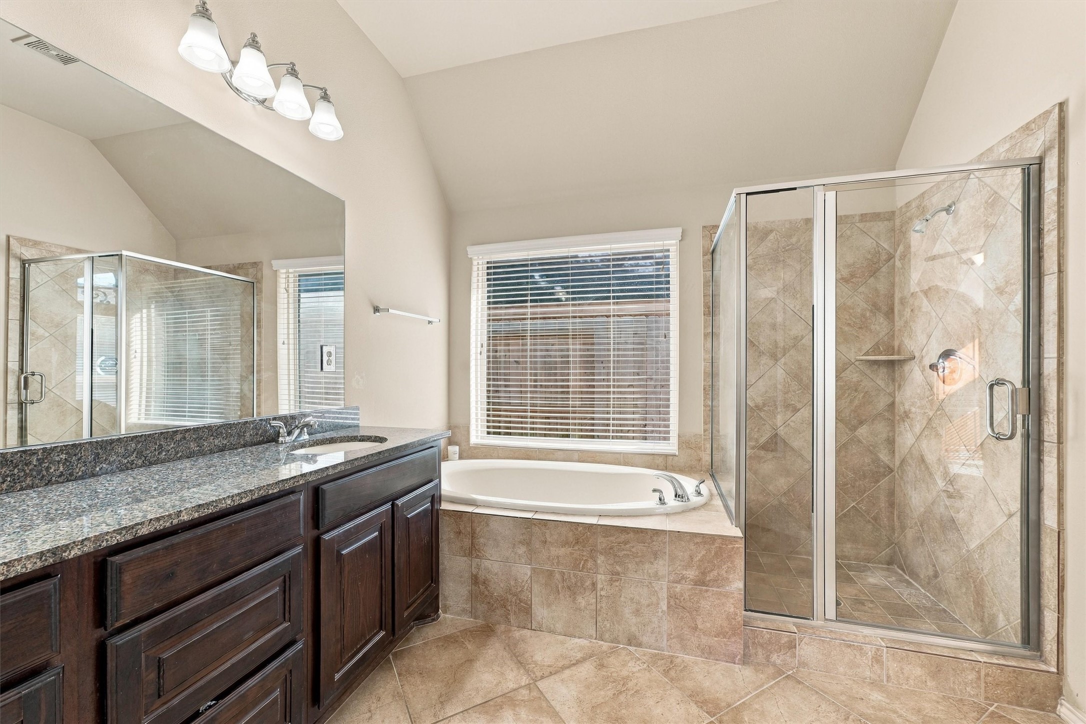 Observe the separate soaking tub and walk in shower with sturdy glass doors.