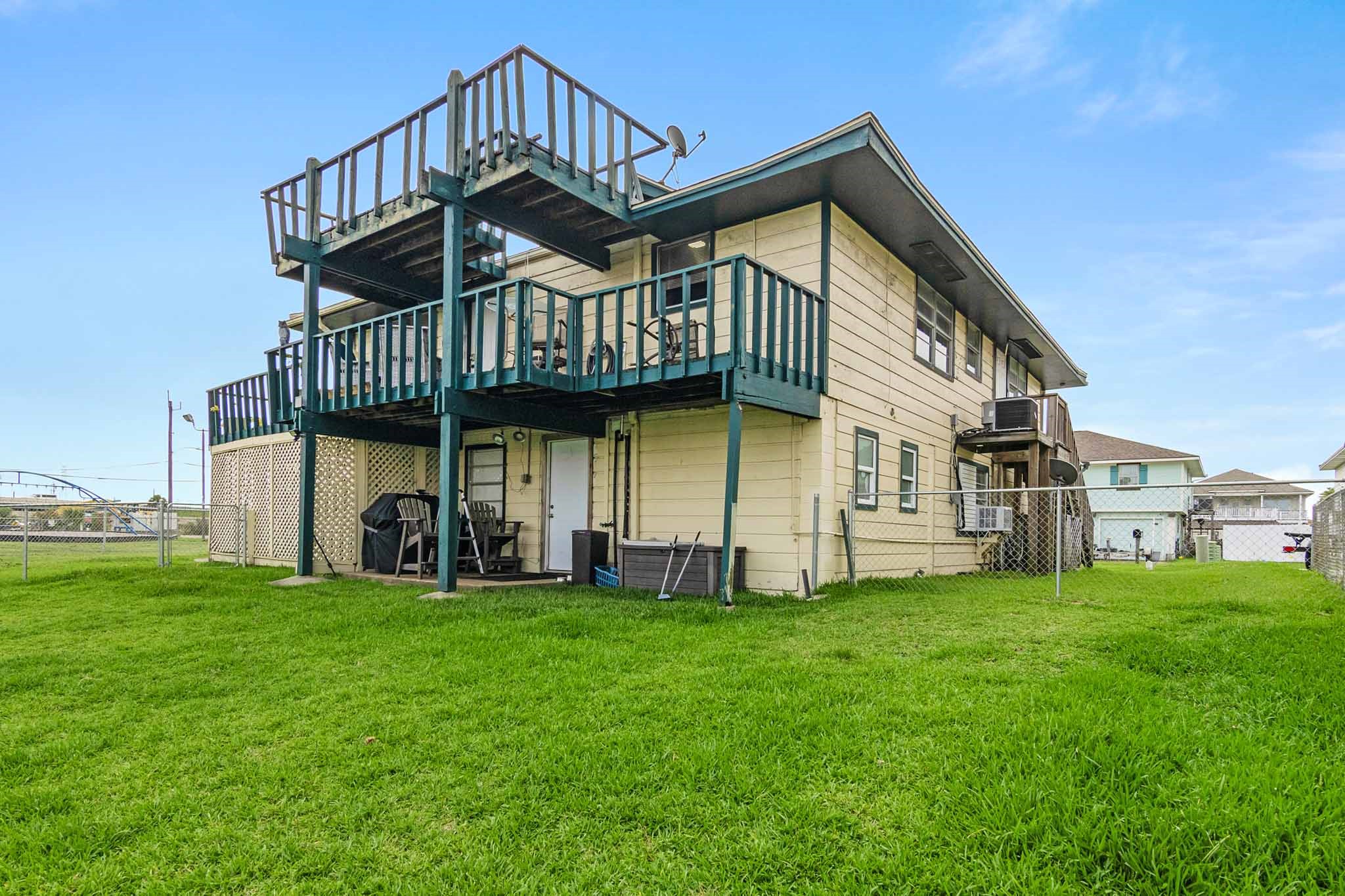 Canal side of home showing deck on second floor and other deck above it. Great views from both decks!