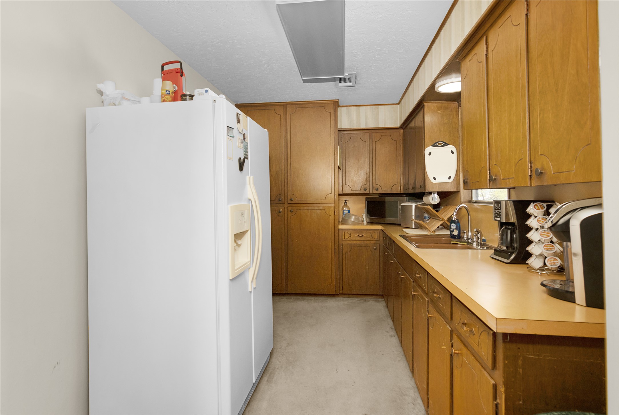 Kitchen in upstairs with refrigerator and pantry.