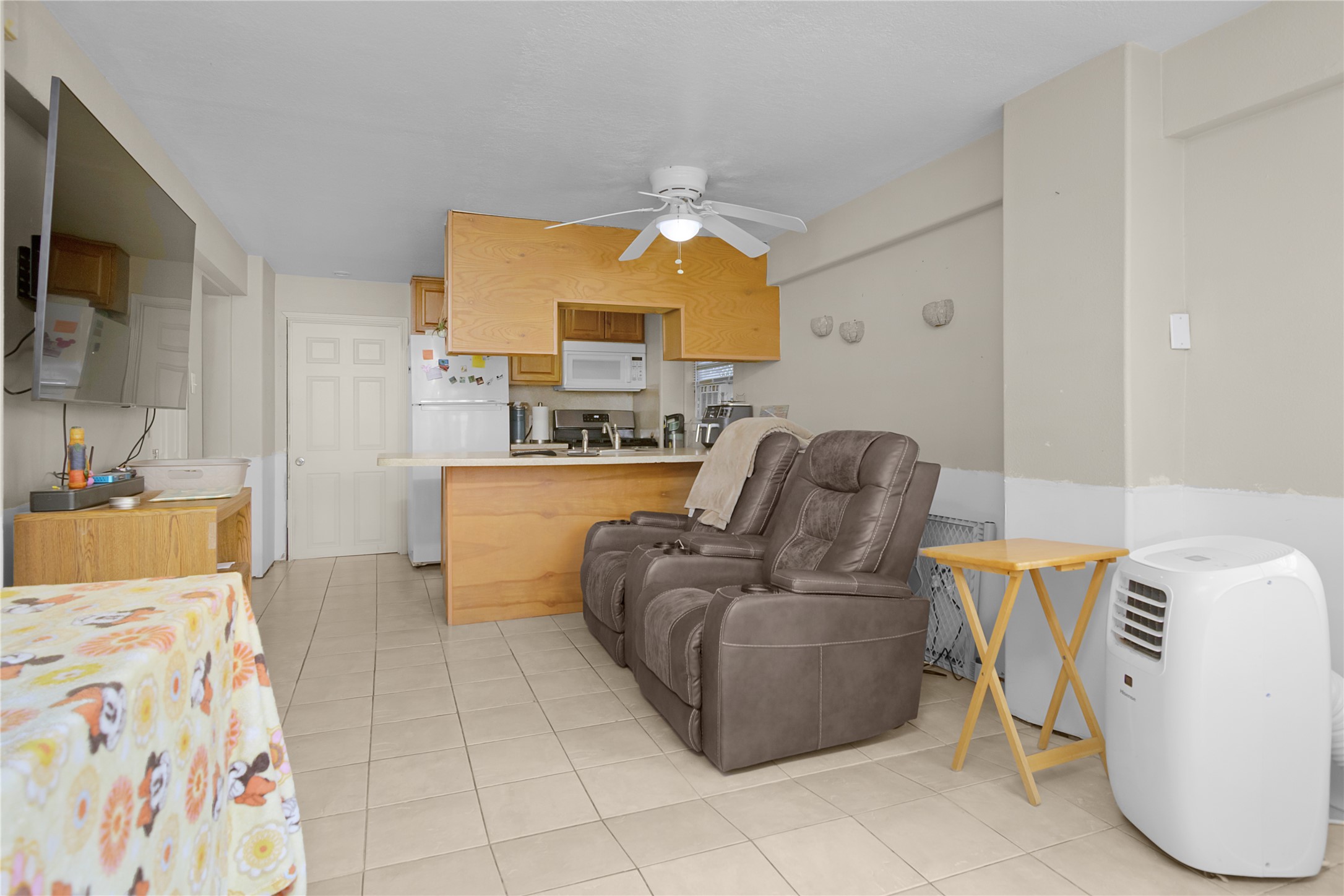 Open living room/kitchen in quarters on the right side.