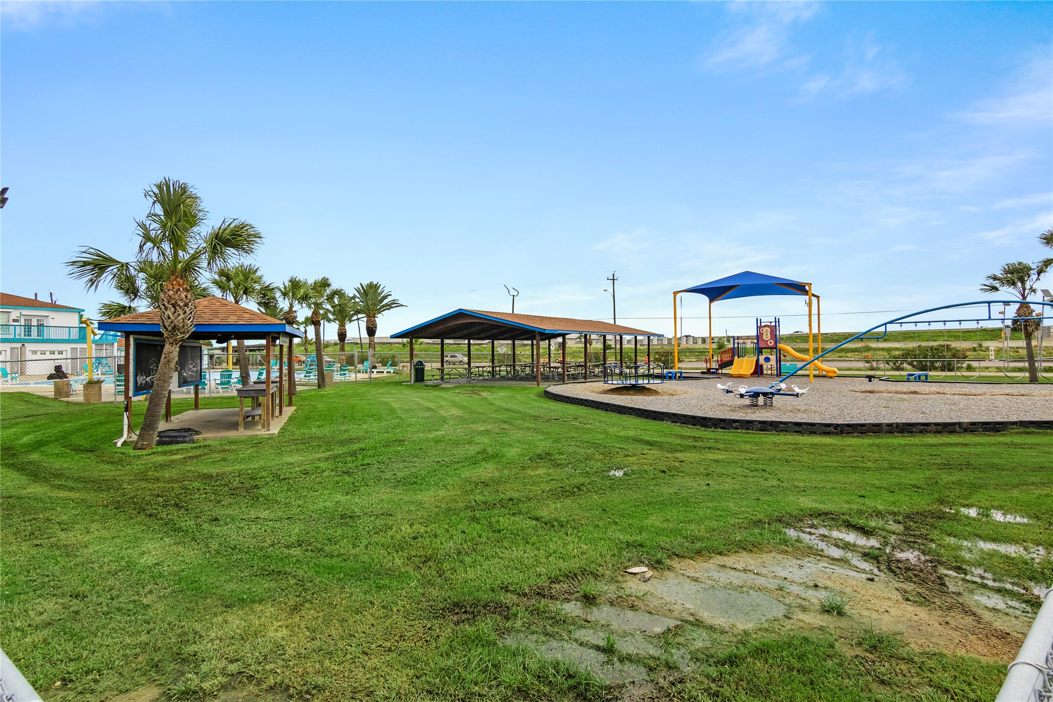 Bayou Vista playground, covered picnic area, community center and gorgeous pool with beautiful palm trees,