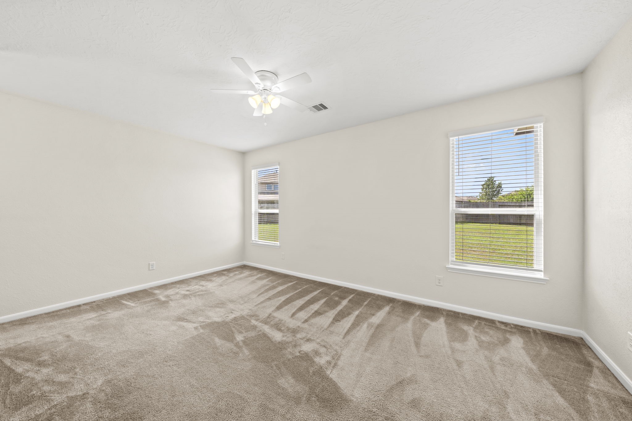 Flooded with natural light, this restful retreat offers direct access to the private bathroom.
