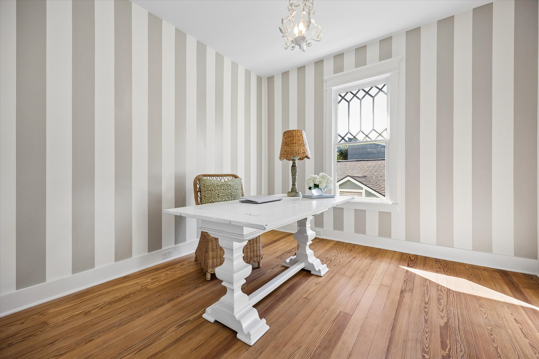 SECONDARY BEDROOM #2, CURRENTLY STAGED AS AN OFFICE. CUSTOM PAINT JOB AND EN-SUITE ACCESS TO SECONDARY BATHROOM.