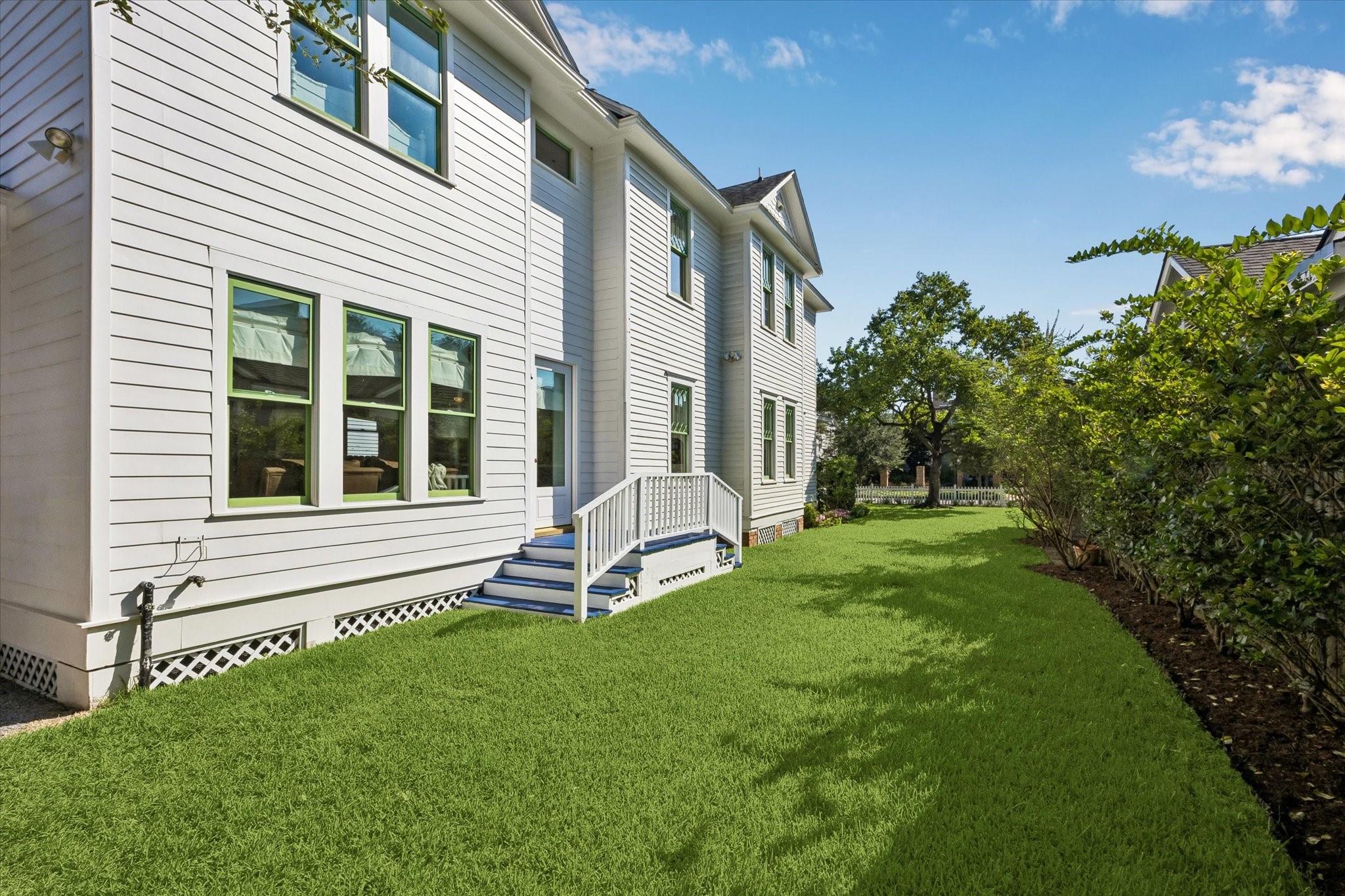 EXPANSIVE LAWN WITH MATURE LANDSCAPING