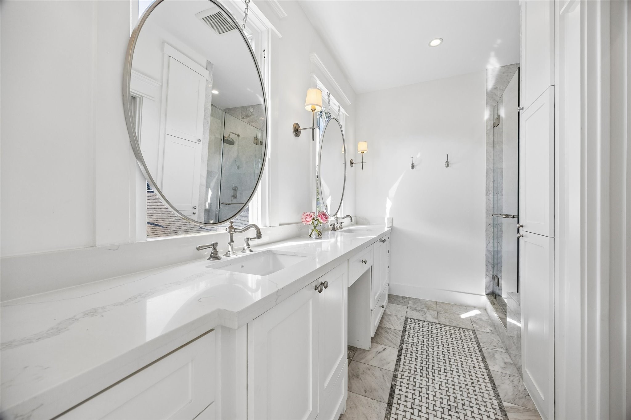 PRIMARY BATHROOM UPDATED WITH MARBLE AND QUARTZ FINISHES, DUAL VANITIES AND A SPACIOUS WALK IN SHOWER