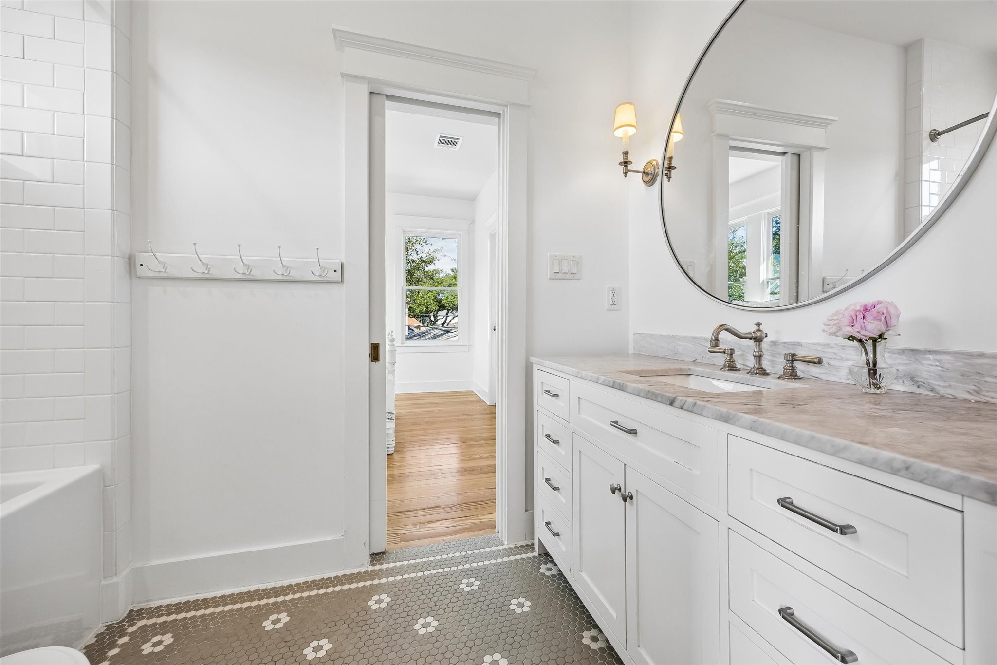 UPDATED SECONDARY BATHROOM WITH TUB/SHOWER COMBO AND MARBLE COUNTERTOP