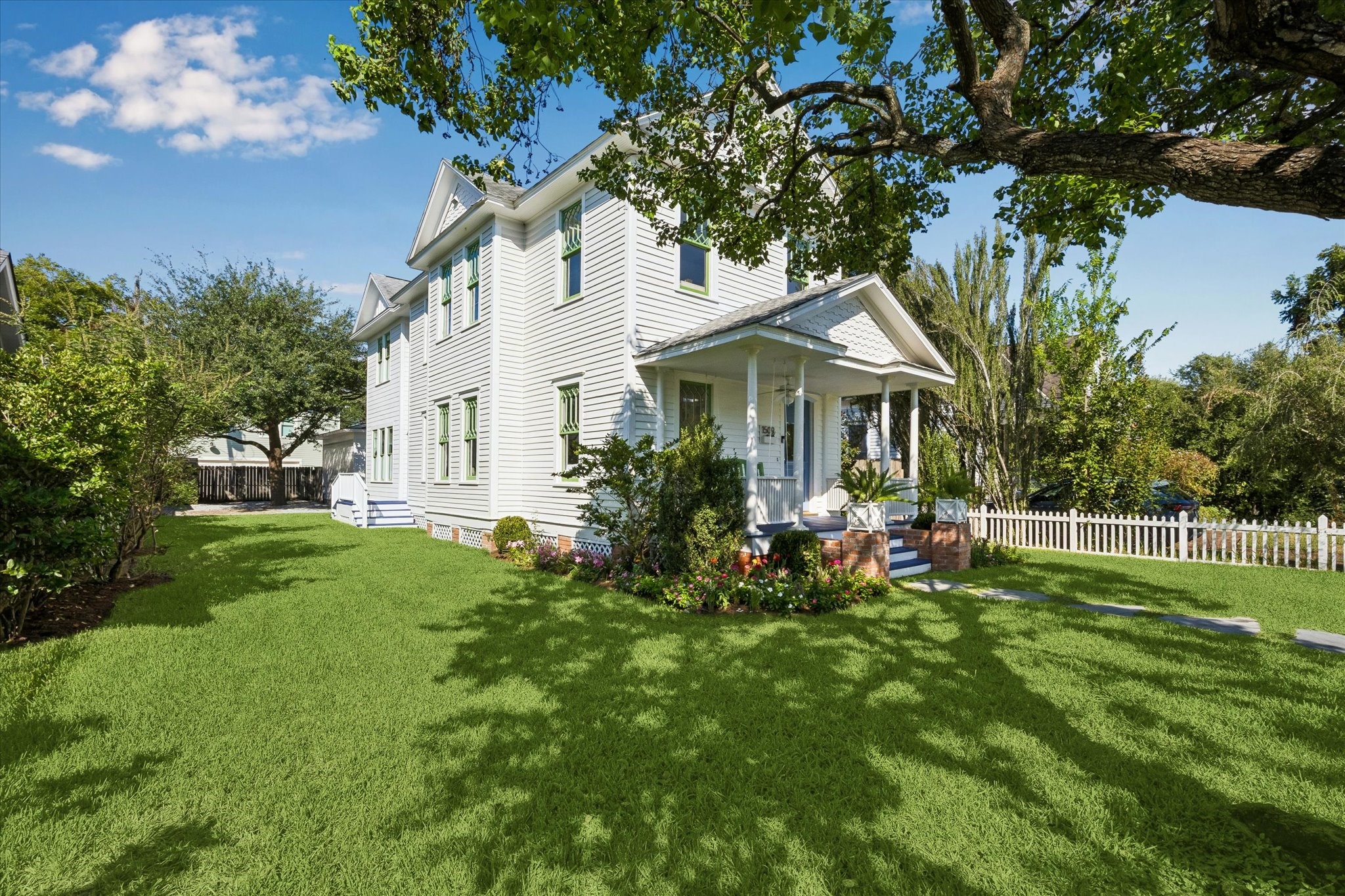CHARMING HOME FRAMED BY MATURE TREES AND LANDSCAPING