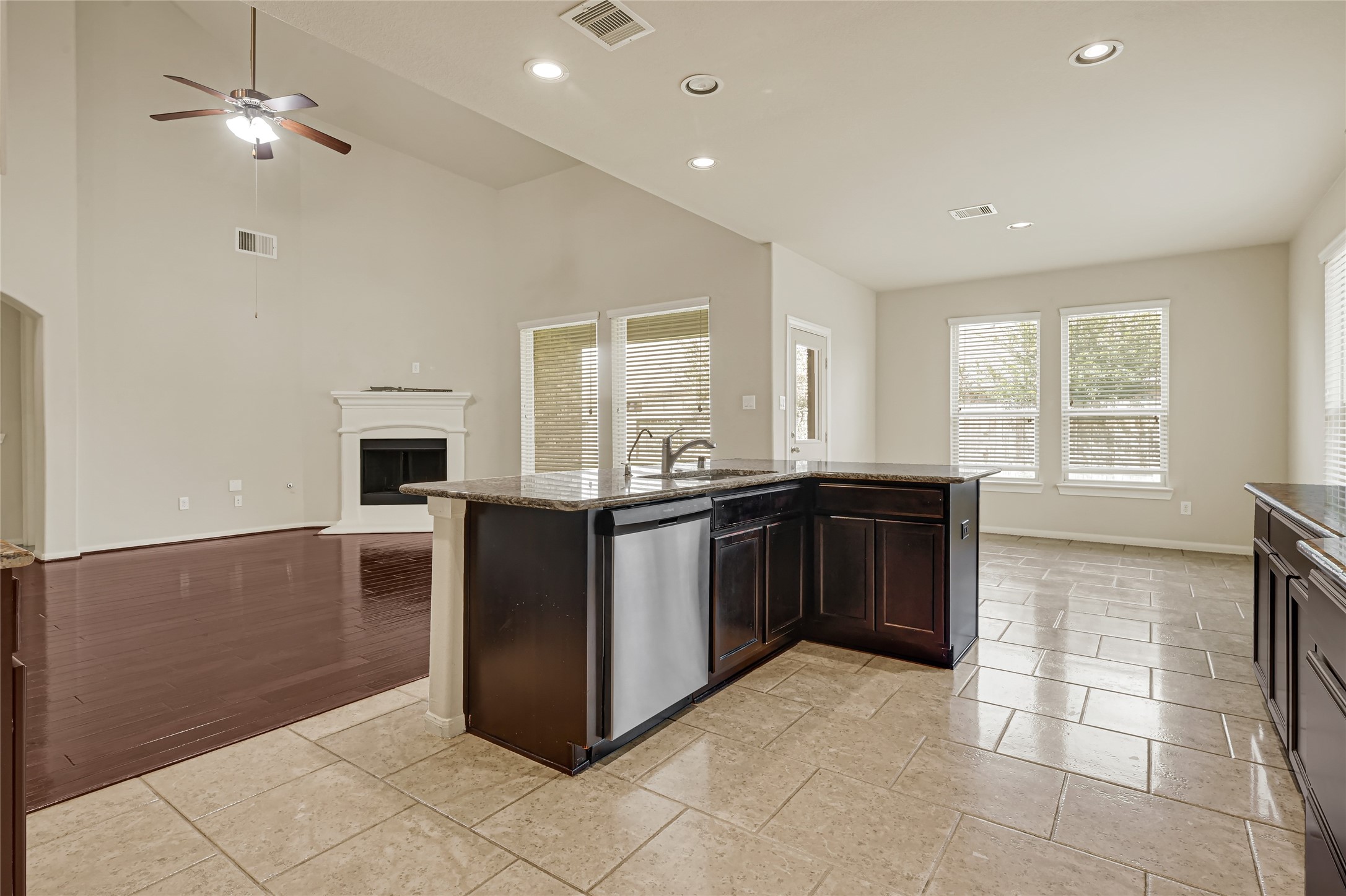 Open kitchen and breakfast space with a center island, abundant natural light, and views into the living area.