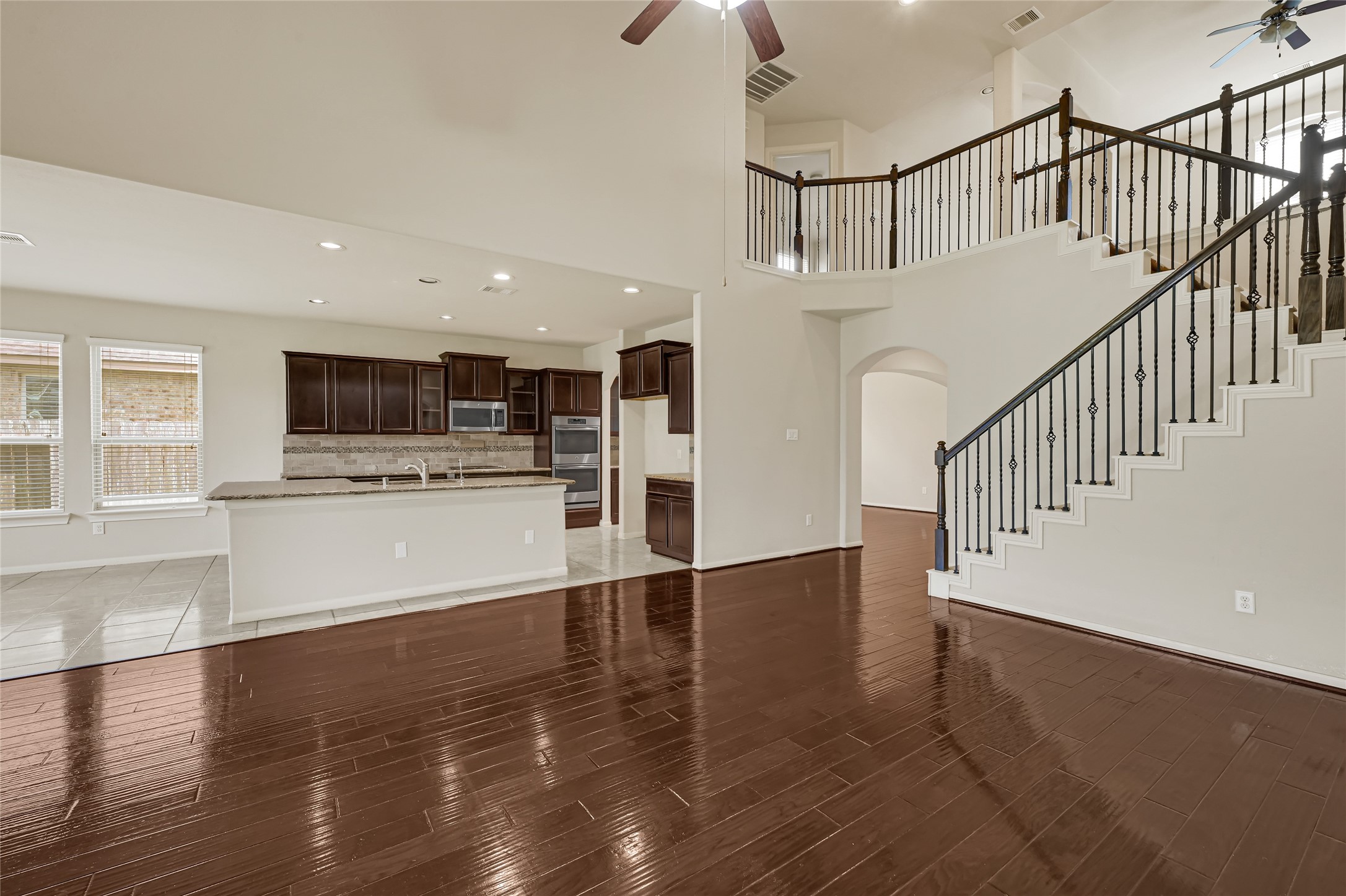 Open-concept living space connecting the kitchen, dining area, and staircase.