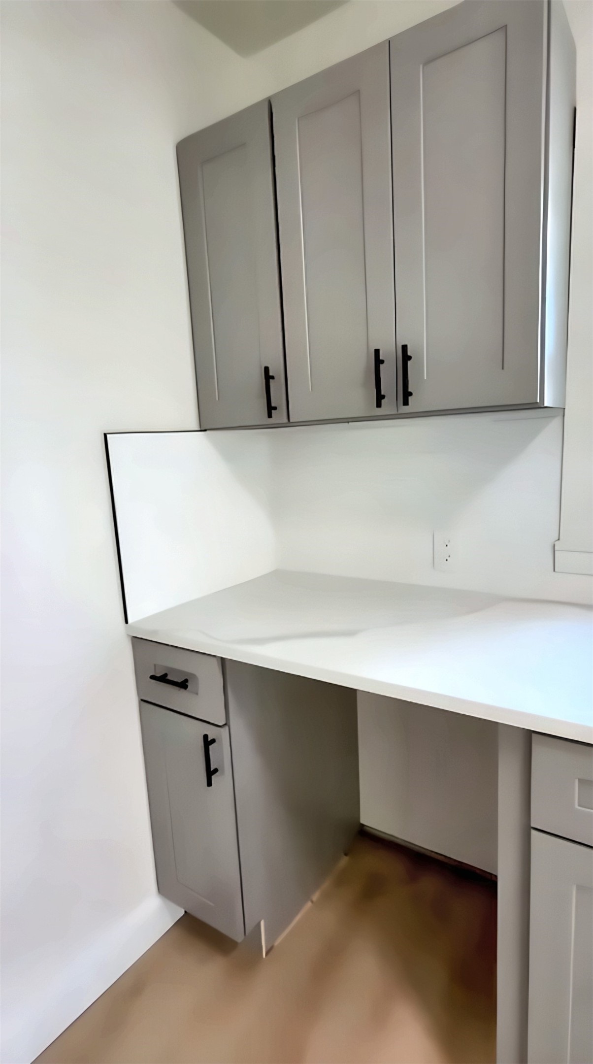 Kitchen counter and gray cabinets with black hardware
