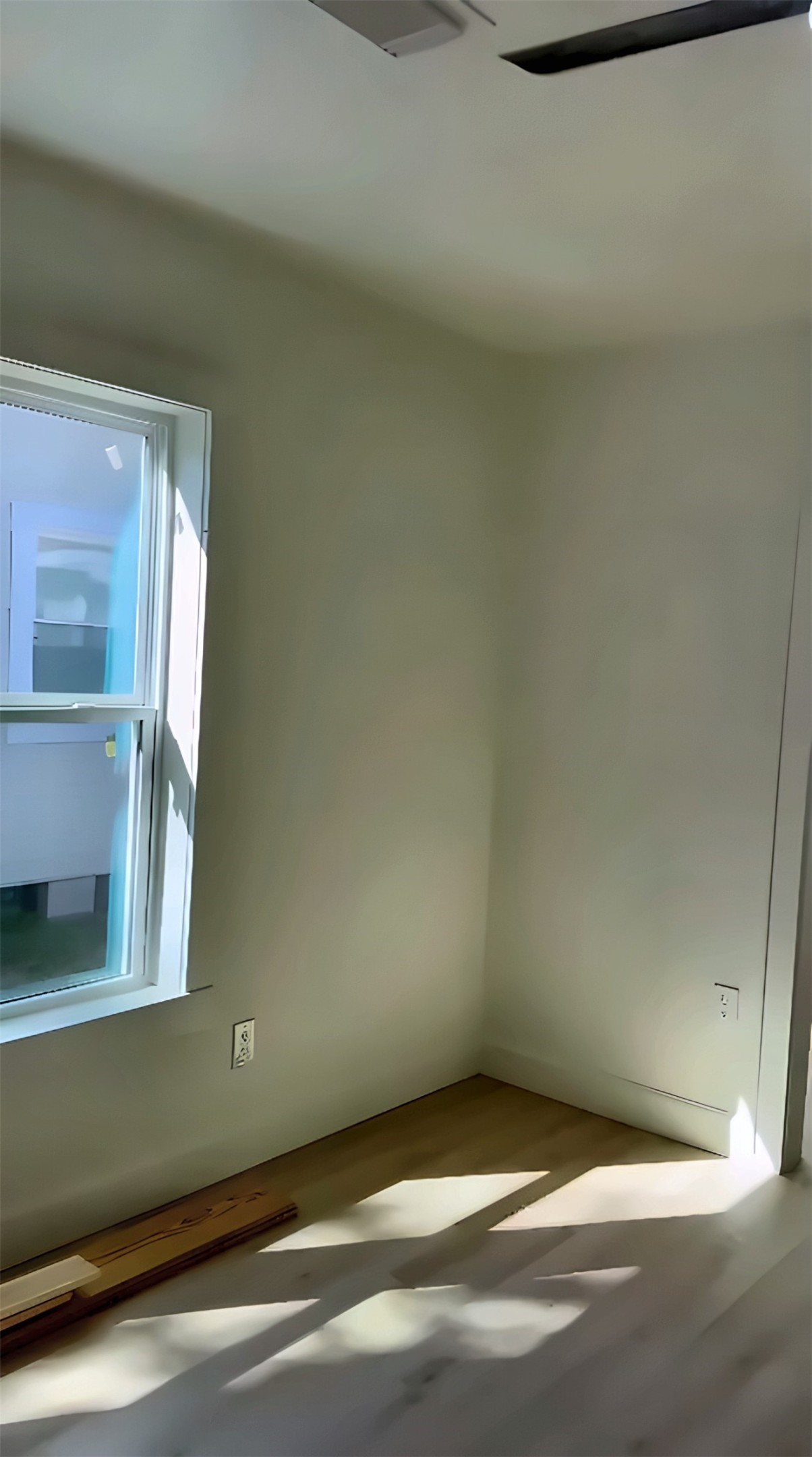 Room with window and wood-look flooring