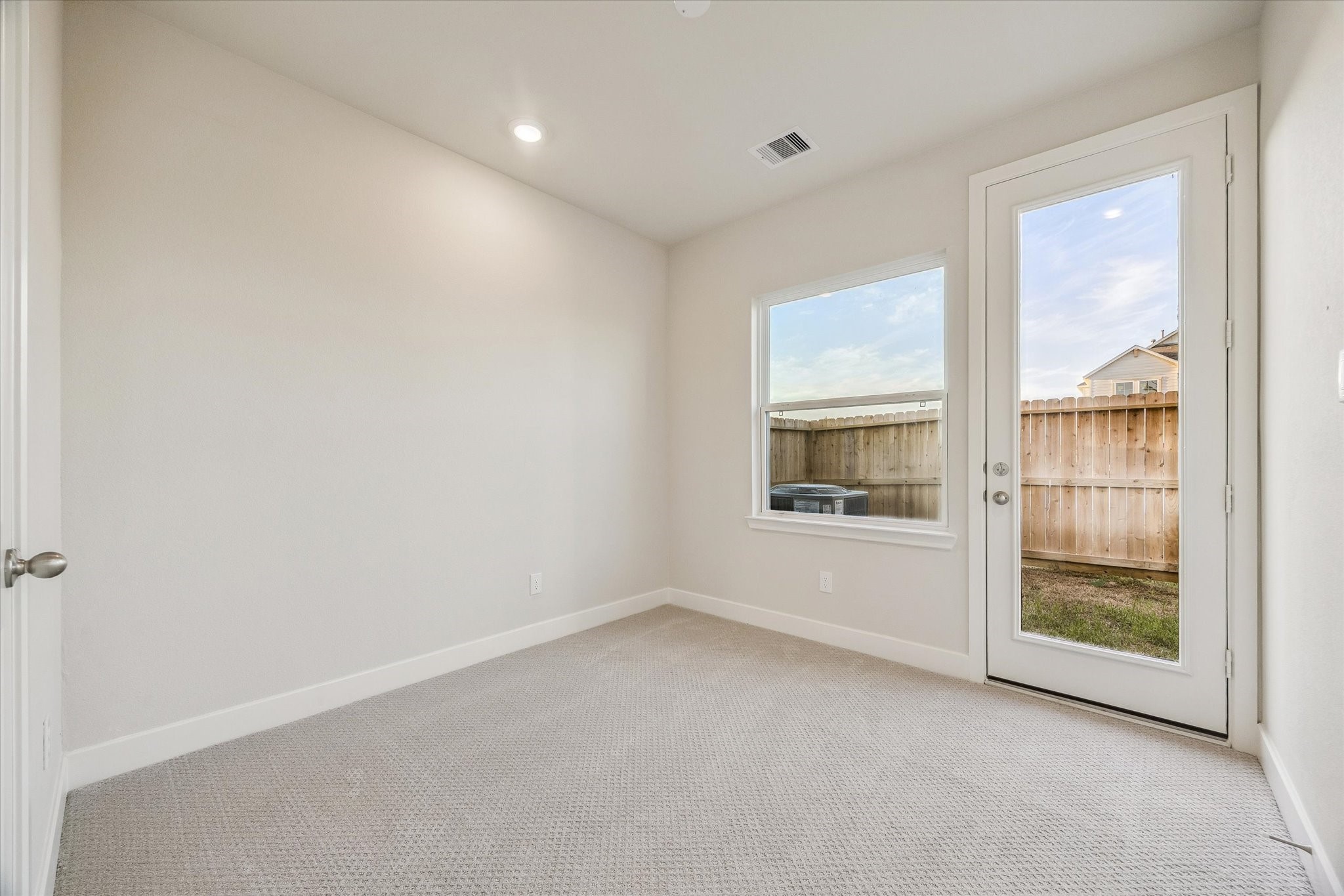 The second secondary bedroom with access to the backyard.