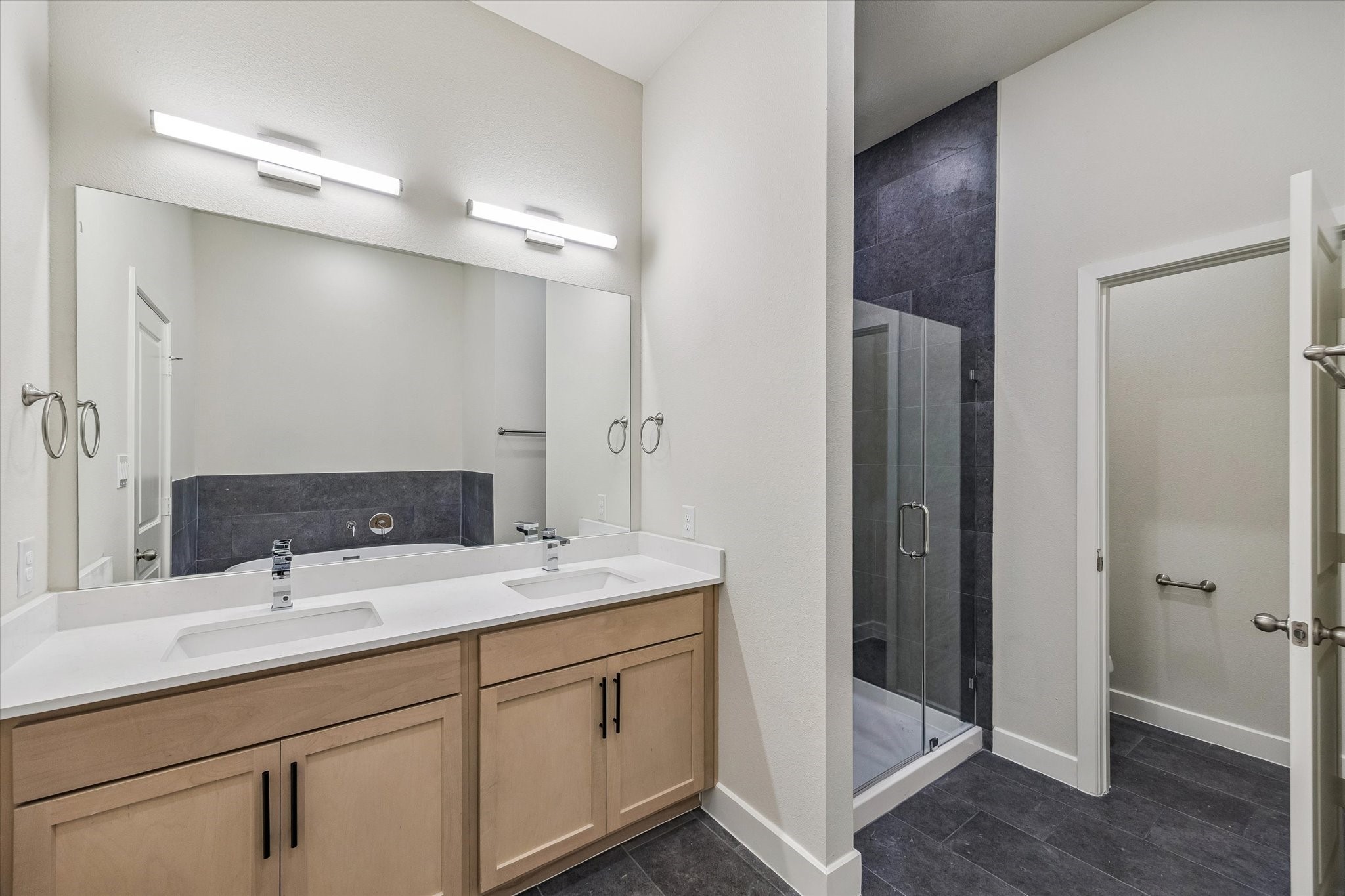 Enjoy the primary bath with dual vanities and a separate shower and tub