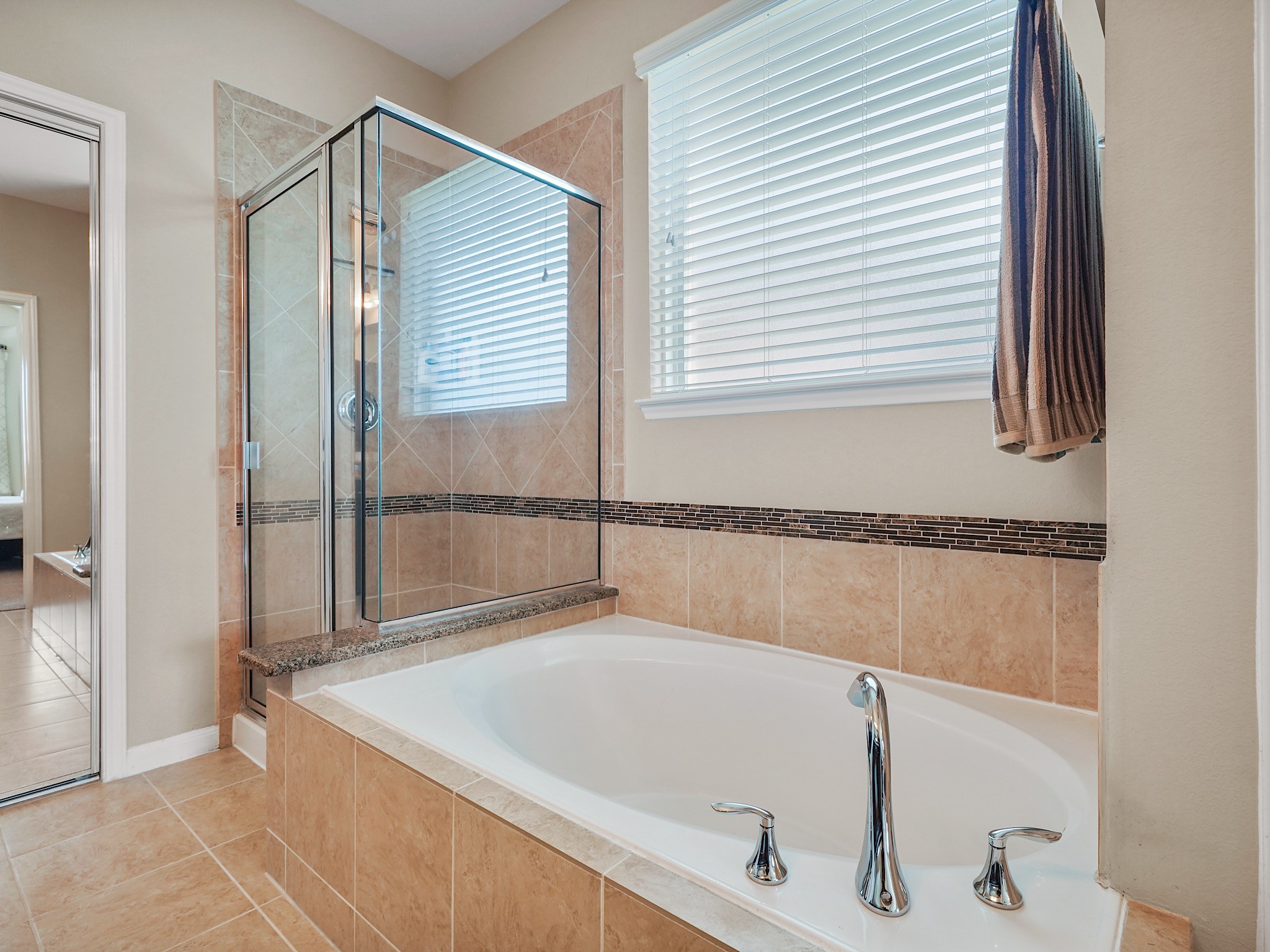 Settle into the soaking tub for a relaxing escape at the end of the day, while the separate glass-enclosed shower offers a refreshing way to start your morning. Together, they create a retreat for both quiet moments and everyday routines.