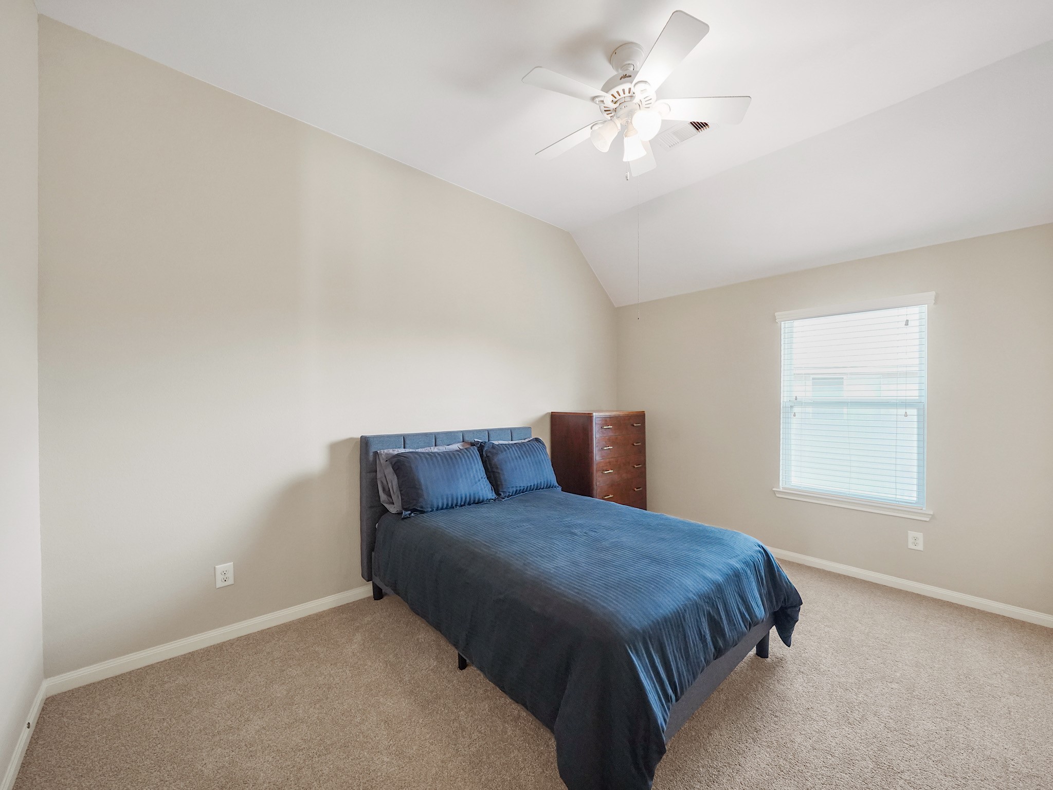 Give overnight guests a space to feel at home in this upstairs bedroom. Whether welcoming visitors for a weekend or a longer stay, it offers a comfortable place for them to settle in.