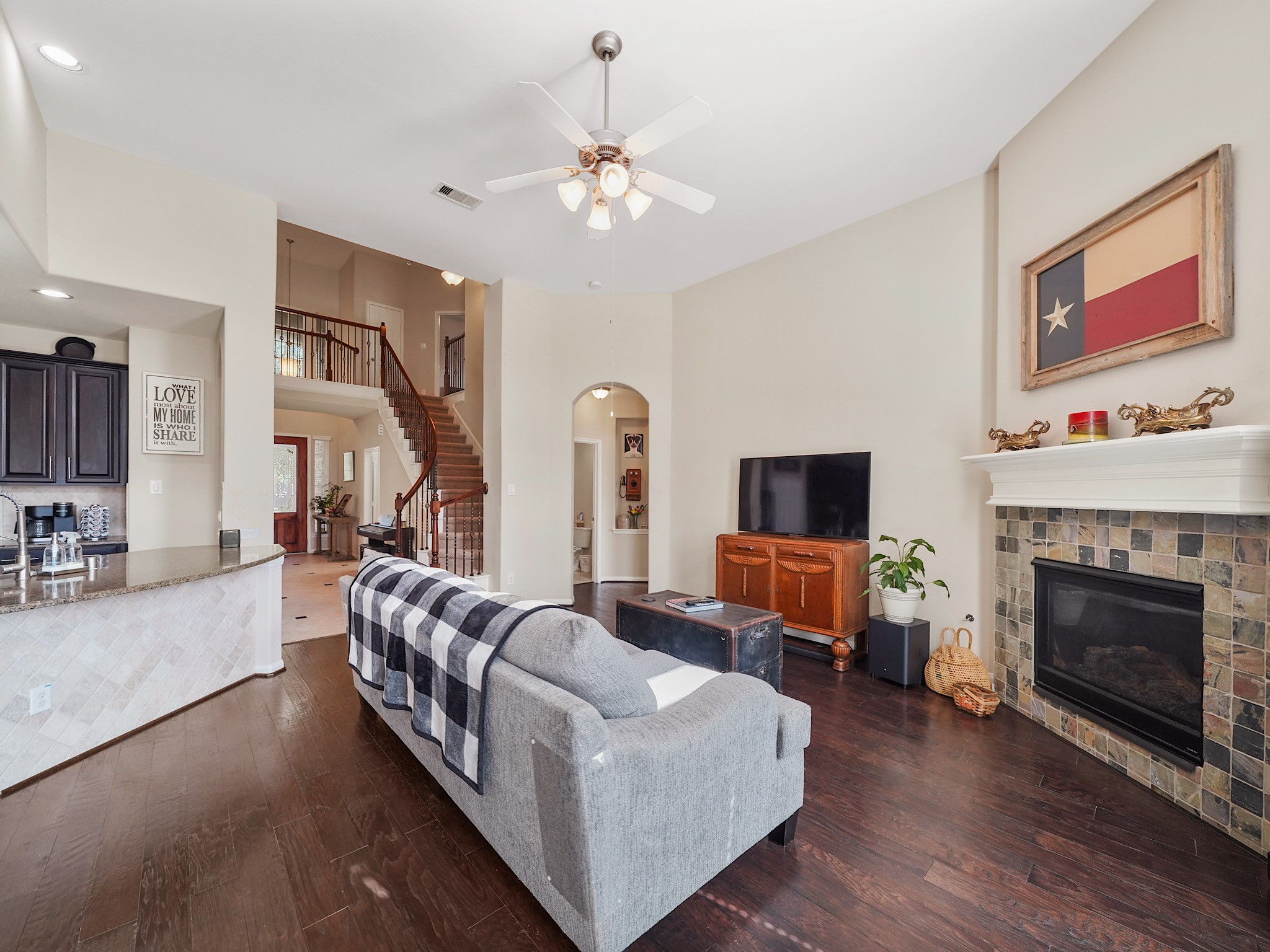 Cozy up in this inviting living room featuring a stunning fireplace, perfect for relaxing evenings.