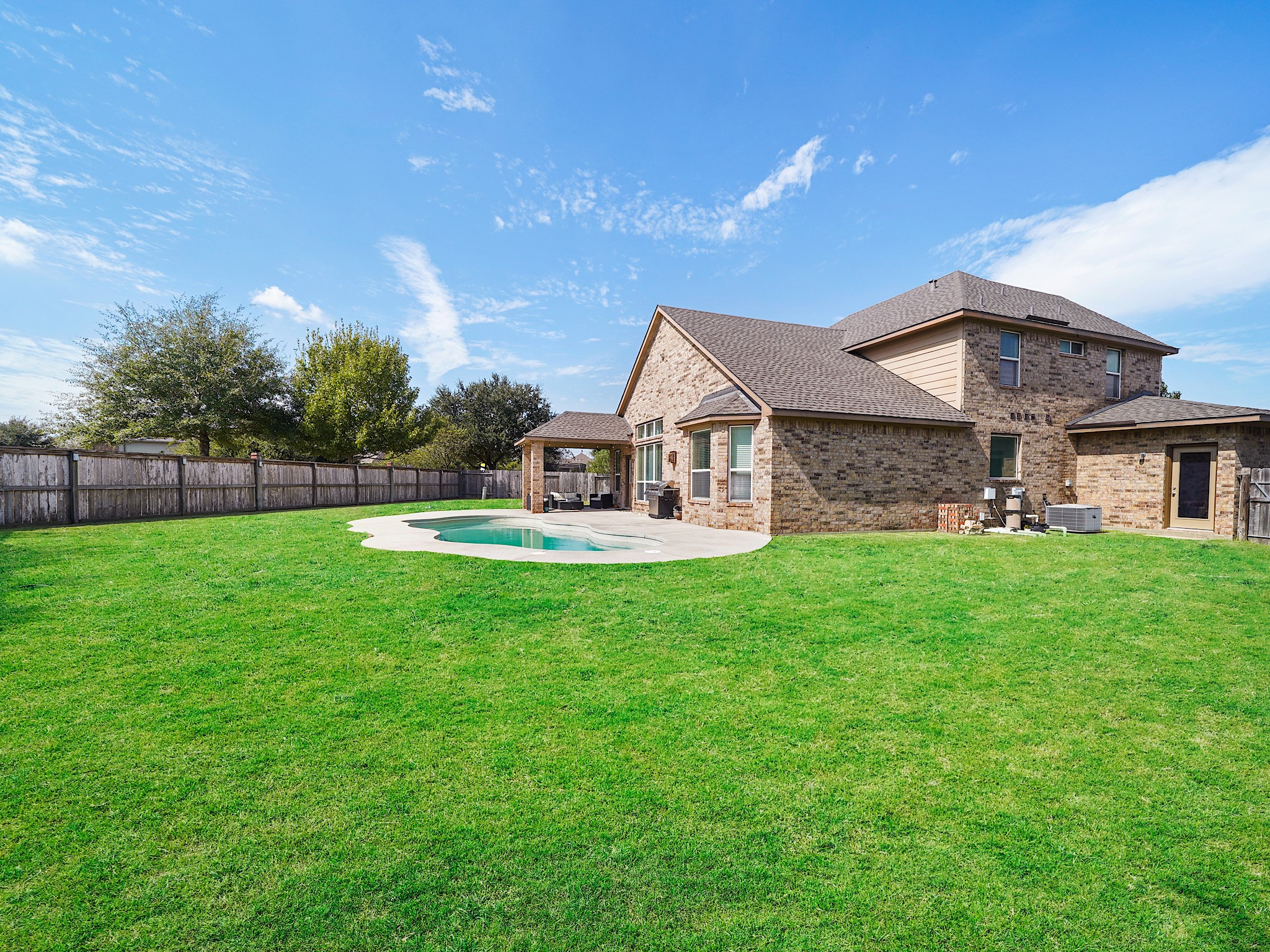 Discover the expansive charm of an oversized yard complete with a refreshing pool, perfect for outdoor enjoyment and relaxation.