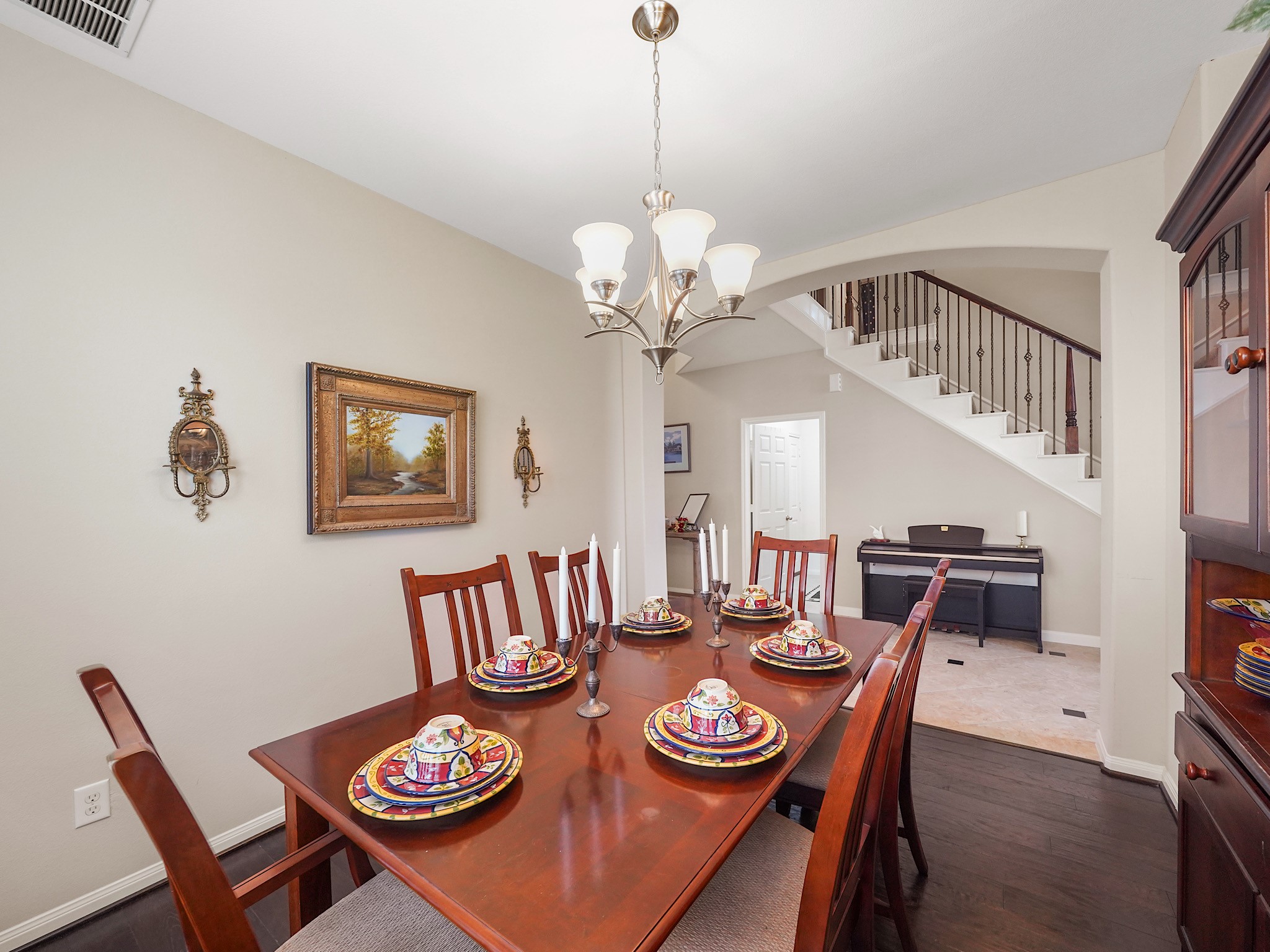 A graceful arched entry frames the dining room, adding architectural character and an elegant transition into the space.