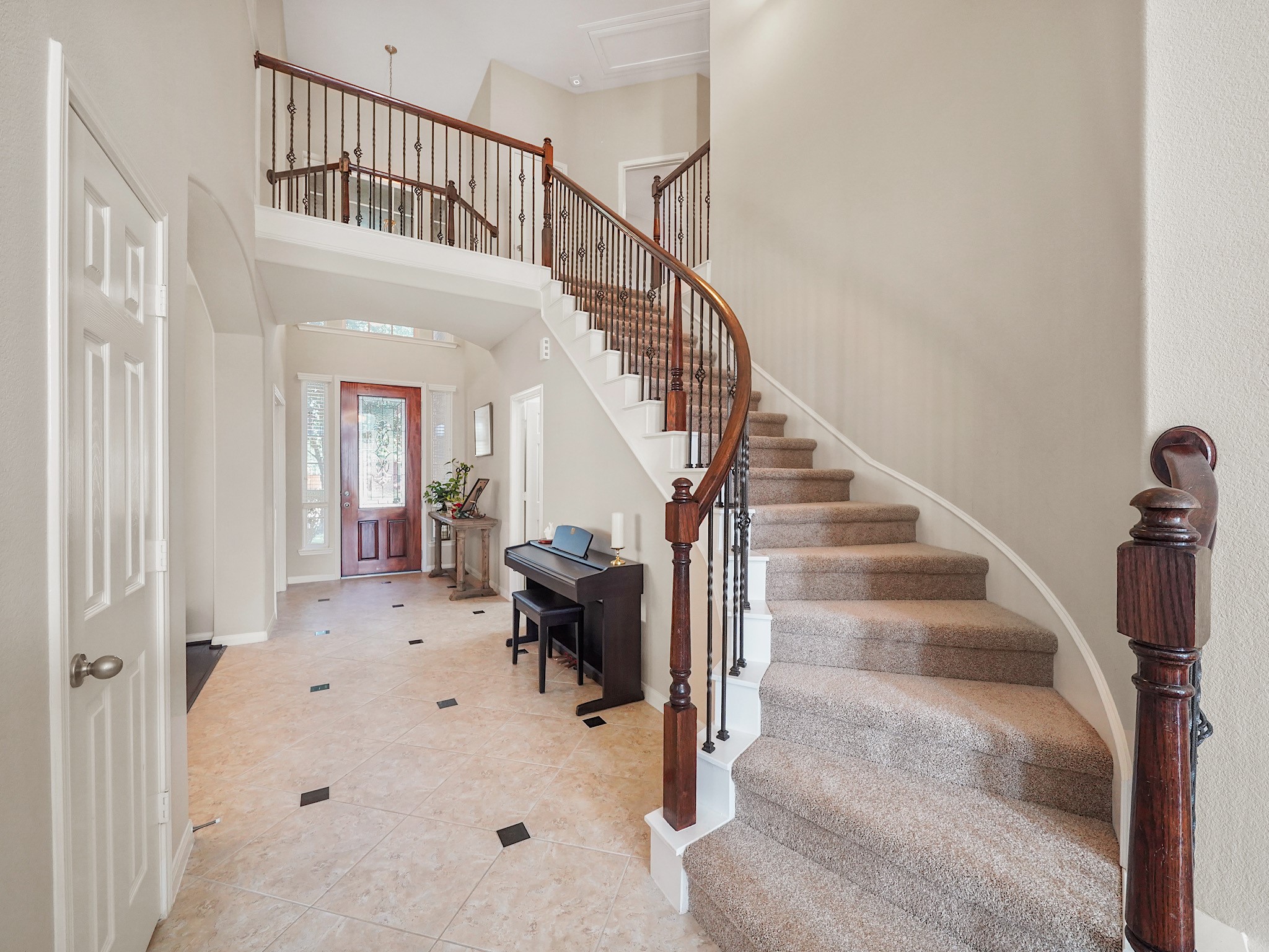 A stunning entrance greets you with a graceful winding staircase, offering an elegant blend of style and sophistication.