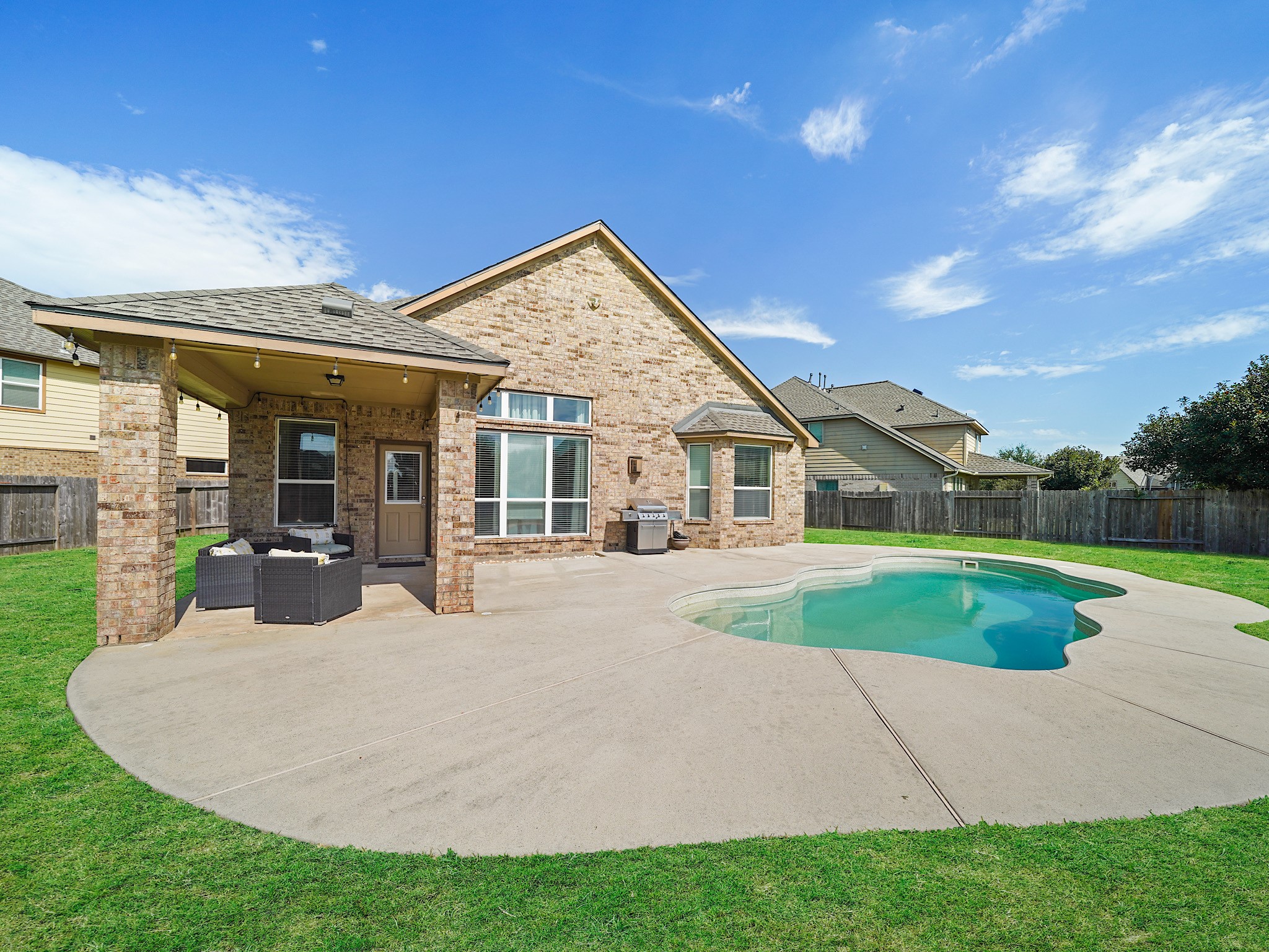 The spacious backyard brings together a covered patio, private pool, and green space for a wonderful balance of relaxation and outdoor enjoyment. Whether youre hosting friends or spending a quiet afternoon at home, theres room to enjoy it all.