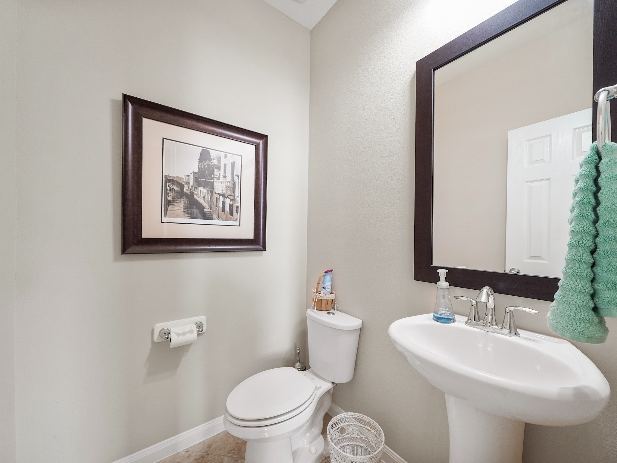The downstairs powder room offers a convenient space for guests and everyday use. Its a thoughtful addition that makes hosting friends and family a little easier.