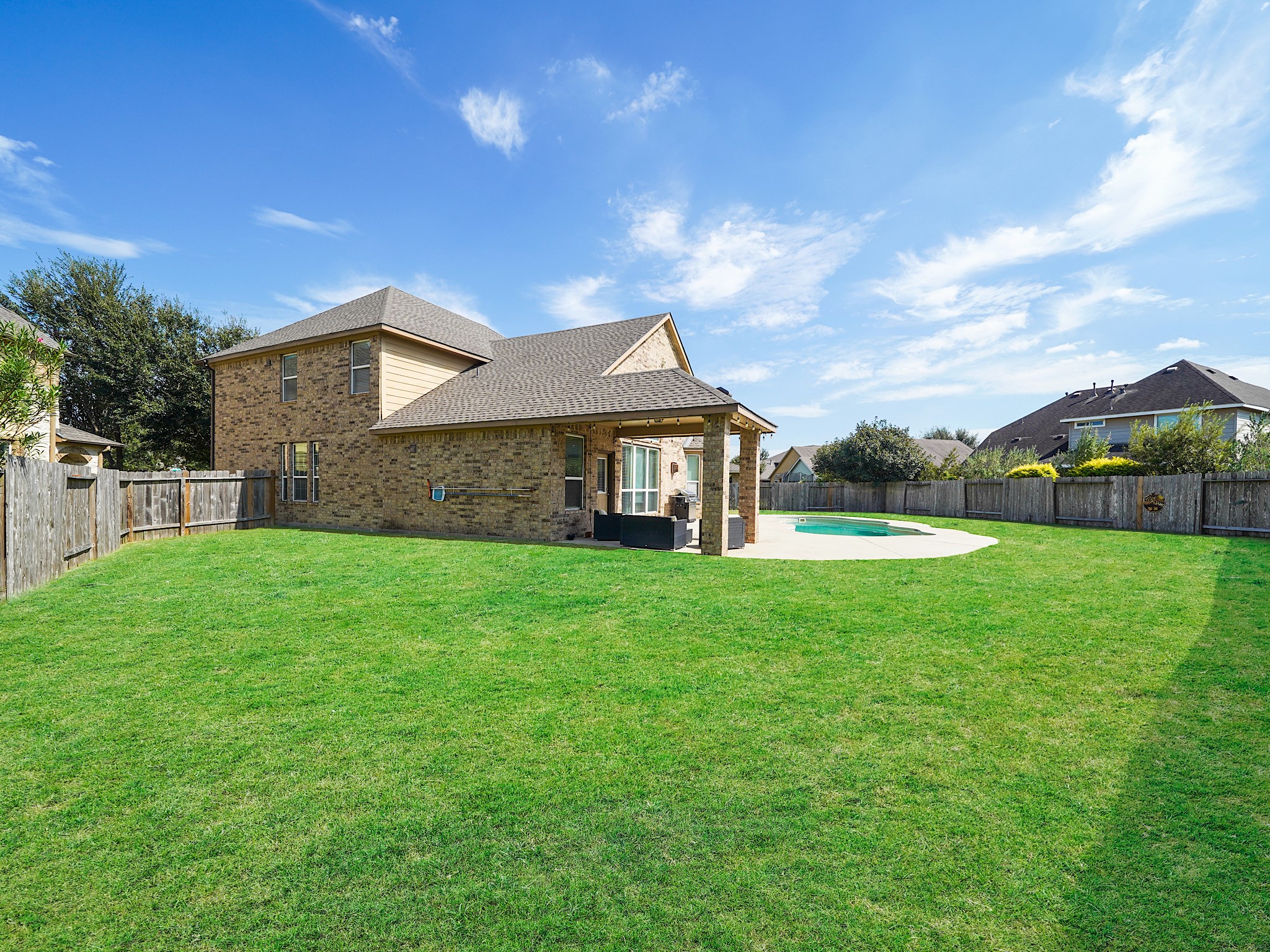 With the covered patio, pool, and plenty of green space, this backyard is the perfect beginning to your dream outdoor oasis. Add your personal touch and create a place for relaxing afternoons, evenings under the stars, and gathering with the people you love.