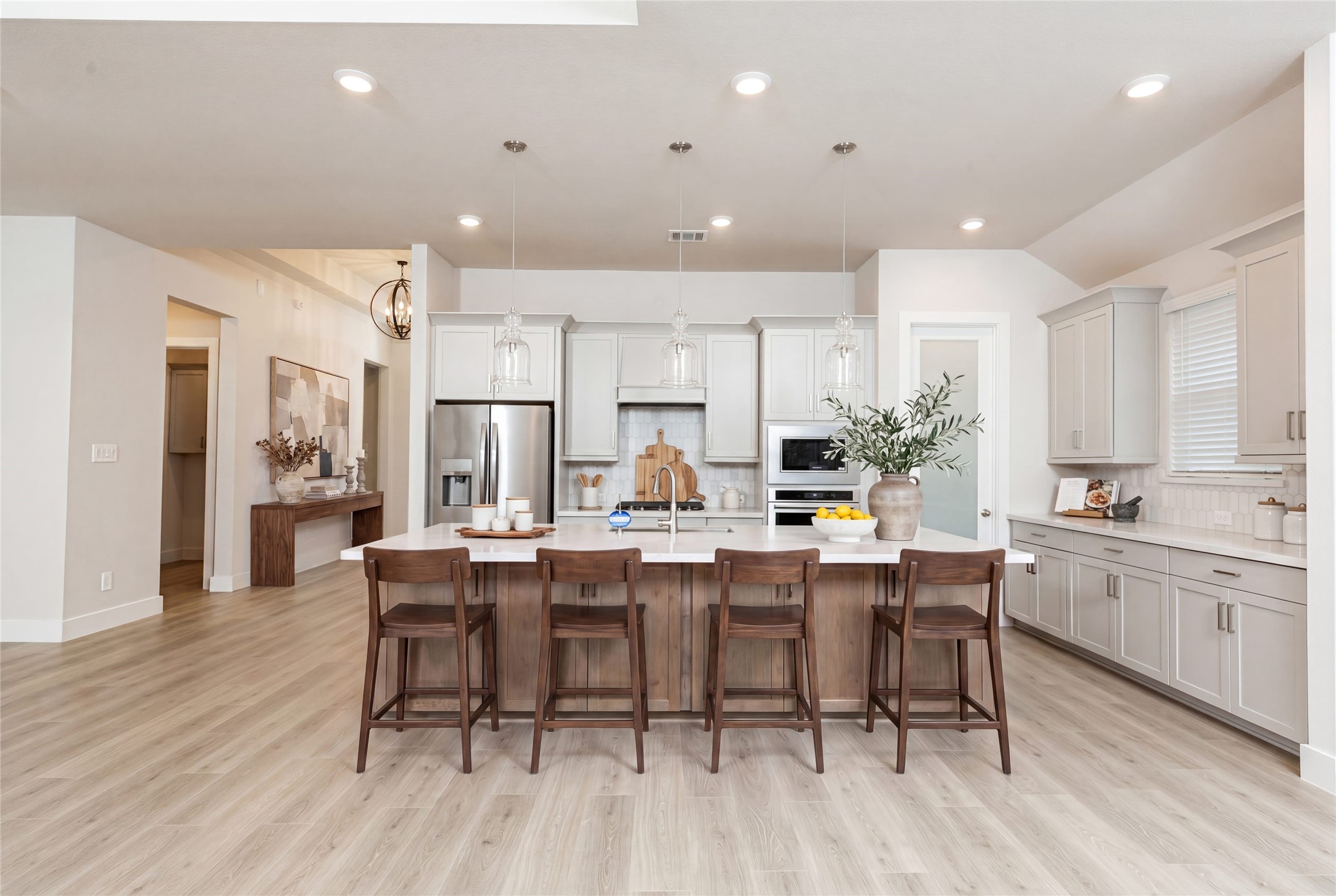 The stunning and generously sized center island features a breakfast bar, perfect for casual dining and entertaining. The island is beautifully designed with pristine quartz countertop and elegant pendant lights. *Virtually Staged.