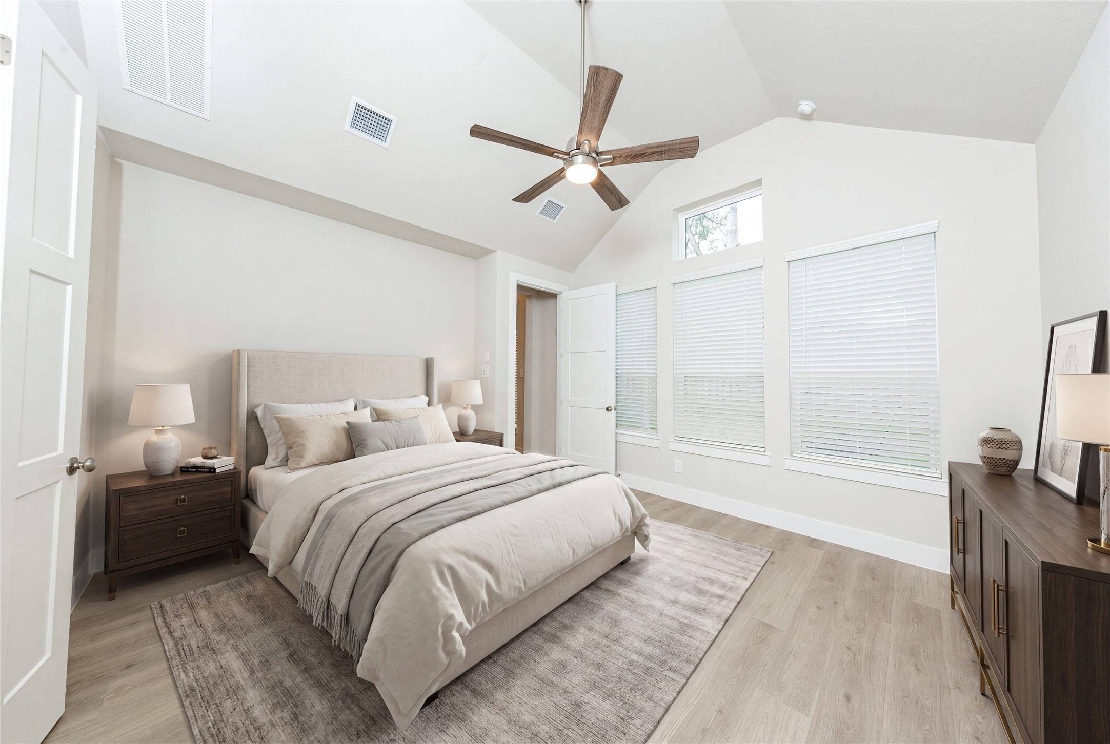 This spacious primary bedroom features an eye-catching architectural niche that offers a dedicated, recessed area perfect for showcasing art, a reading nook, or extra decor, adding custom character without taking up valuable floor space. *Virtually Staged.