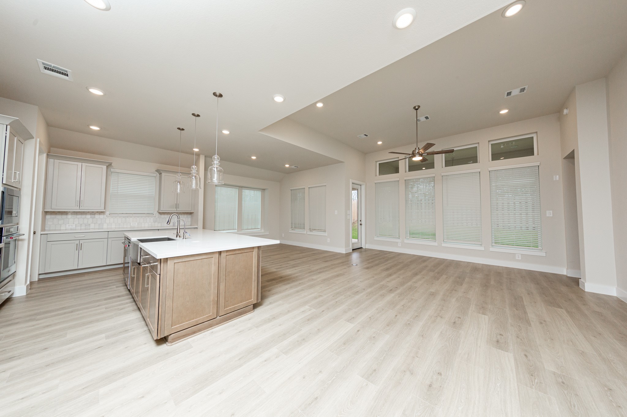 Enjoy a seamless flow between the living, dining and kitchen areas, perfect for entertaining. Access the tranquil outdoors through a modern, full-lite glass patio door which provides abundant natural light and an open view of the private fenced backyard.