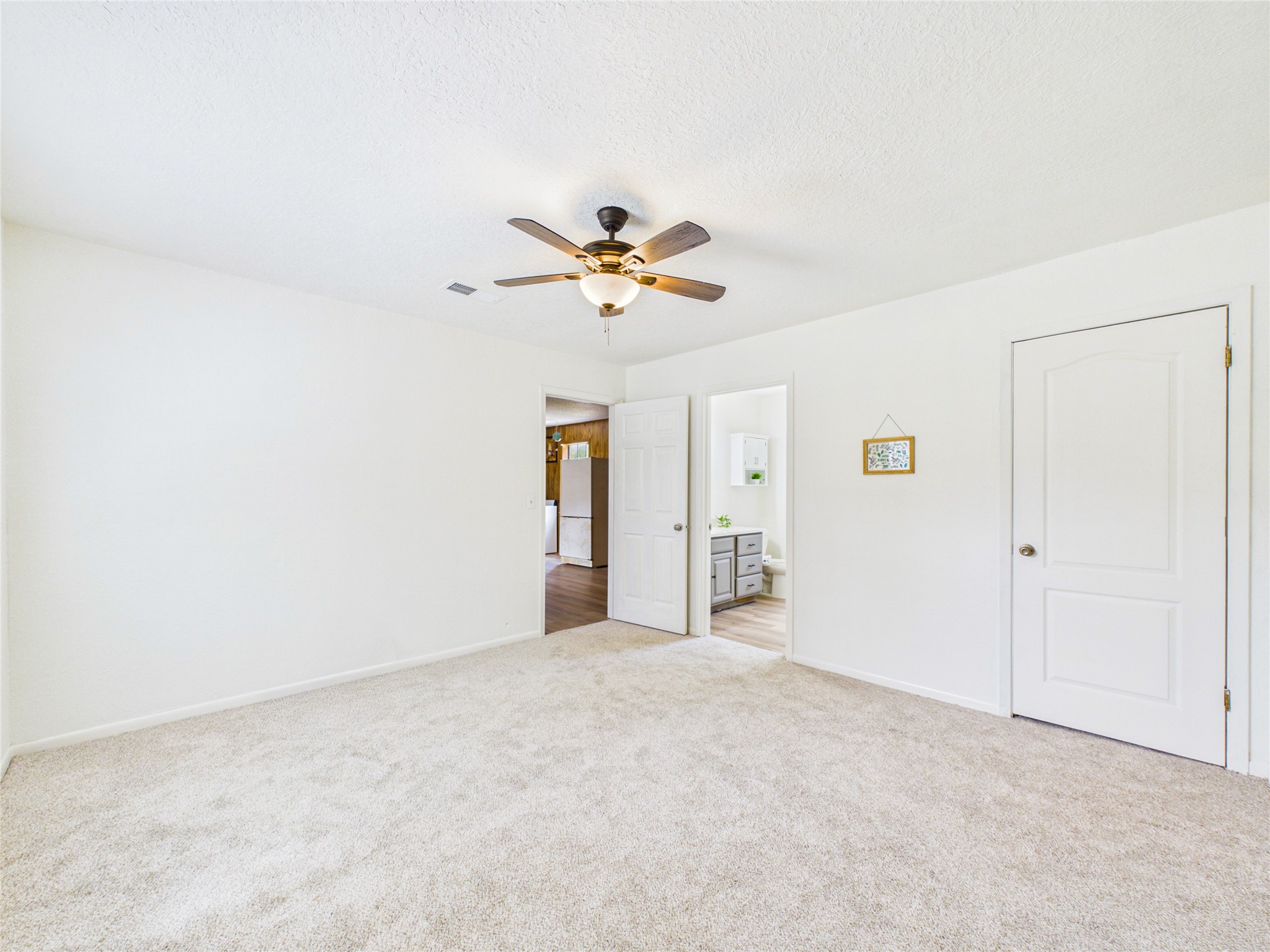 Bedroom in garage apt, view towards living areas and bathroom