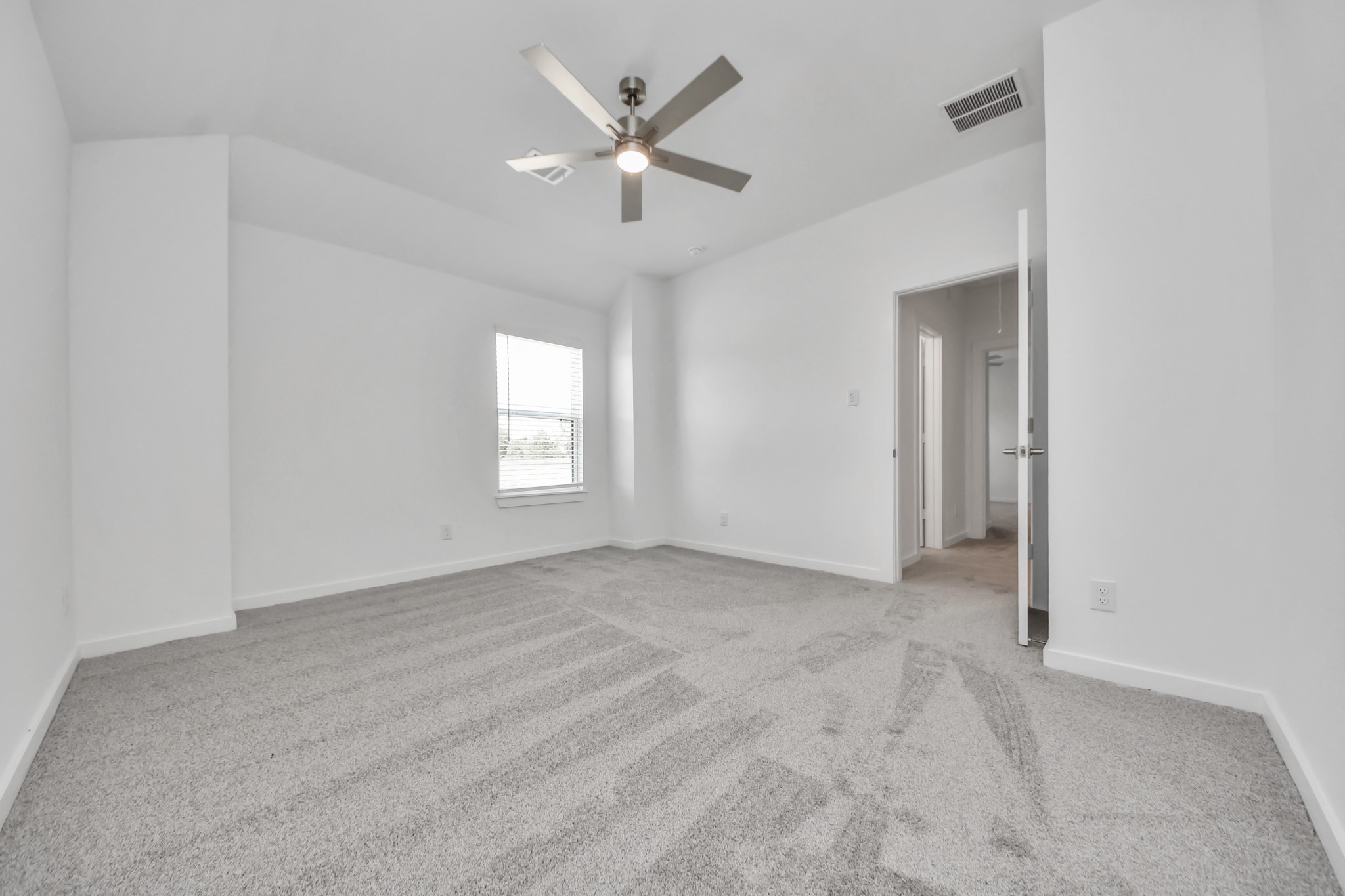 Generously sized secondary bedrooms featuring spacious closets, soft and inviting carpeting underfoot, large windows allowing plenty of natural light, and the added touch of privacy blinds for your personal retreat.